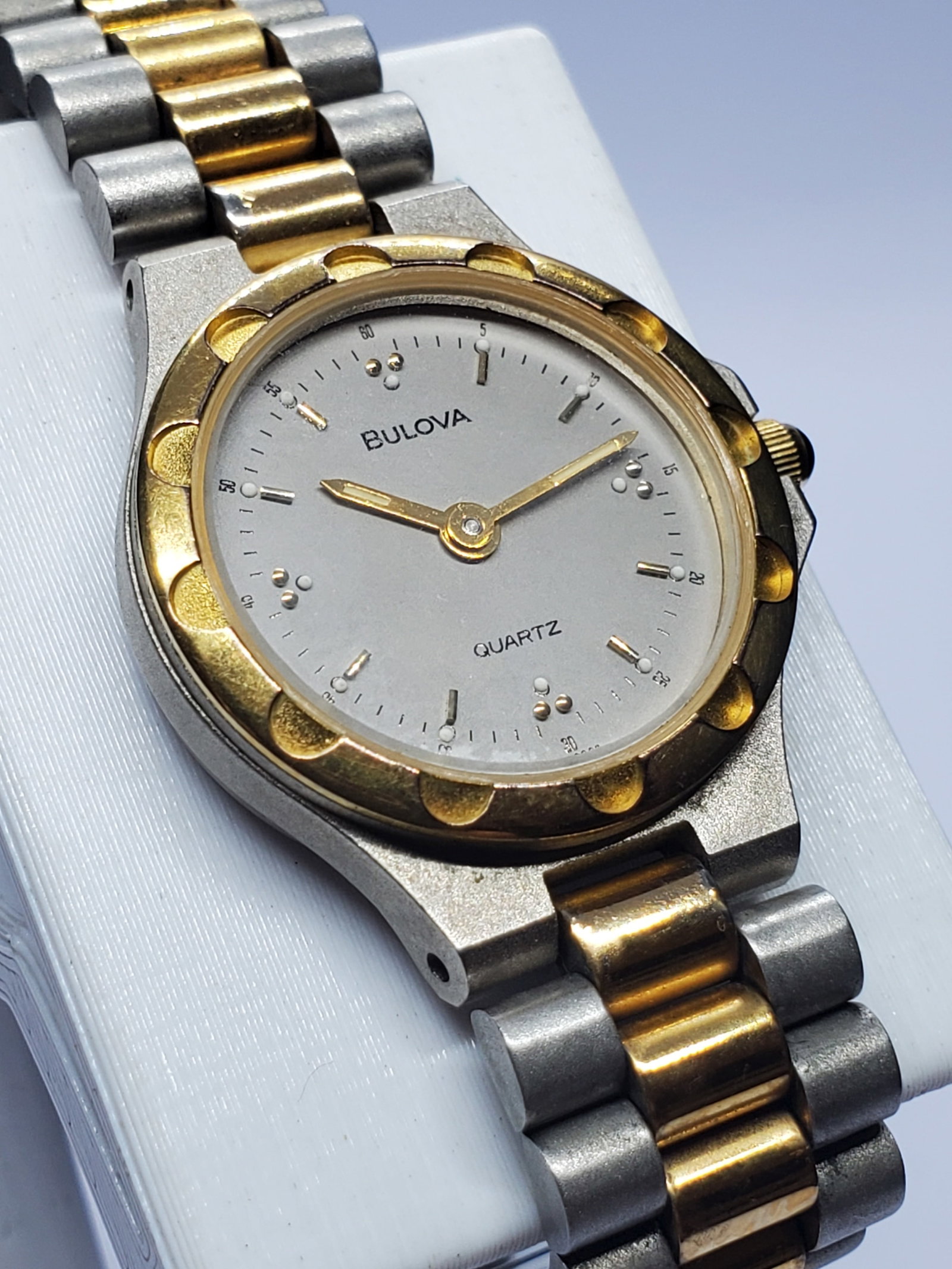 Bulova Quartz Dress Watch Two Tone Gold Bezel Vintage 22mm, 1990s, Working: Elegant and timeless, this Bulova quartz dress watch showcases the refined design language that has made Bulova a respected name in horology since its founding by Joseph Bulova in 1875 in New York. Kn