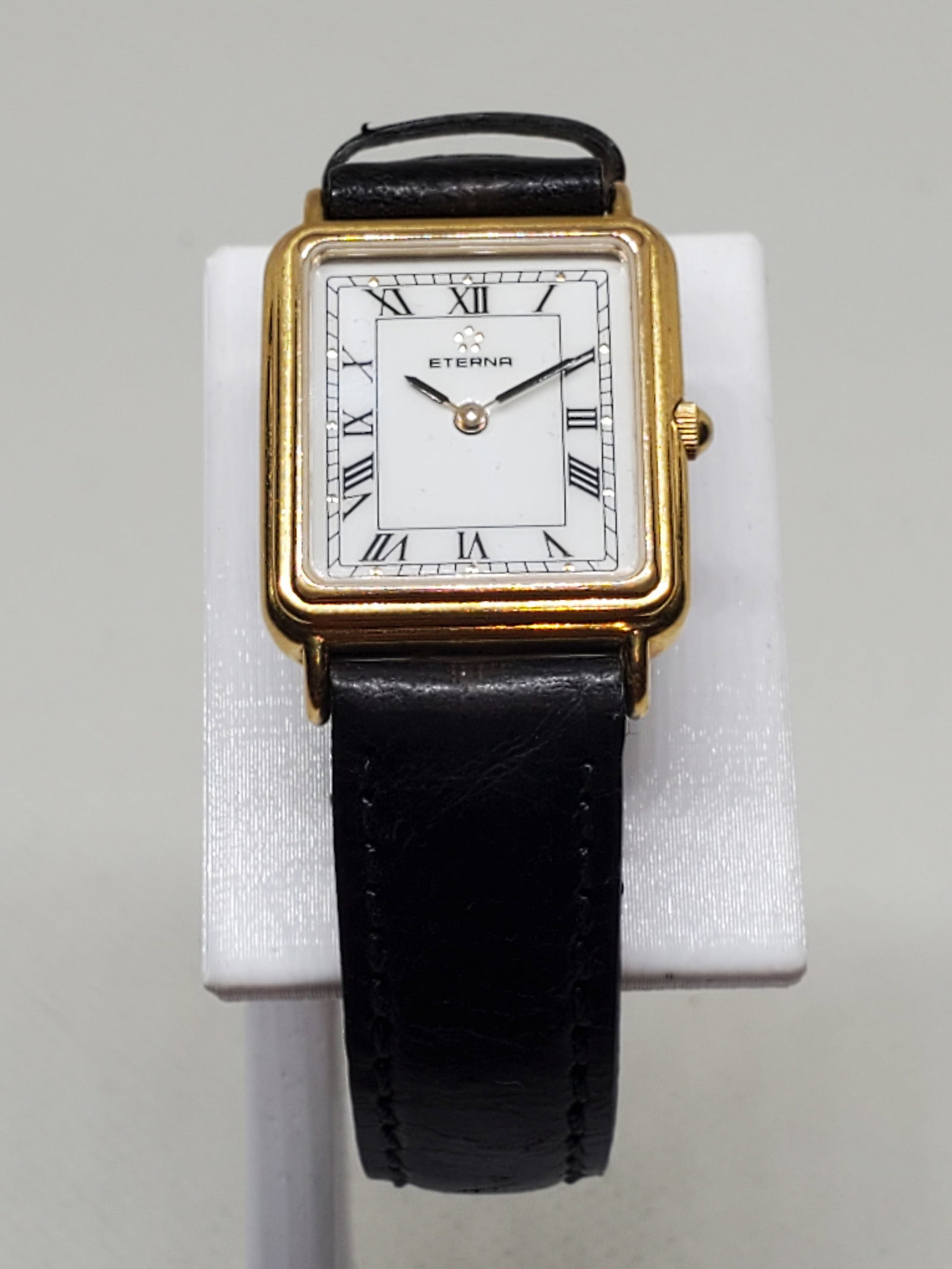 Eterna Gold Plated Ladies Watch, 1980s, Working: Eterna 133.2191.22.S running Quartz Luxury Watch exuding understated elegance and Swiss prestige, this Eterna timepiece features a refined gold tone tank case, classic white dial, and Roman numeral ho