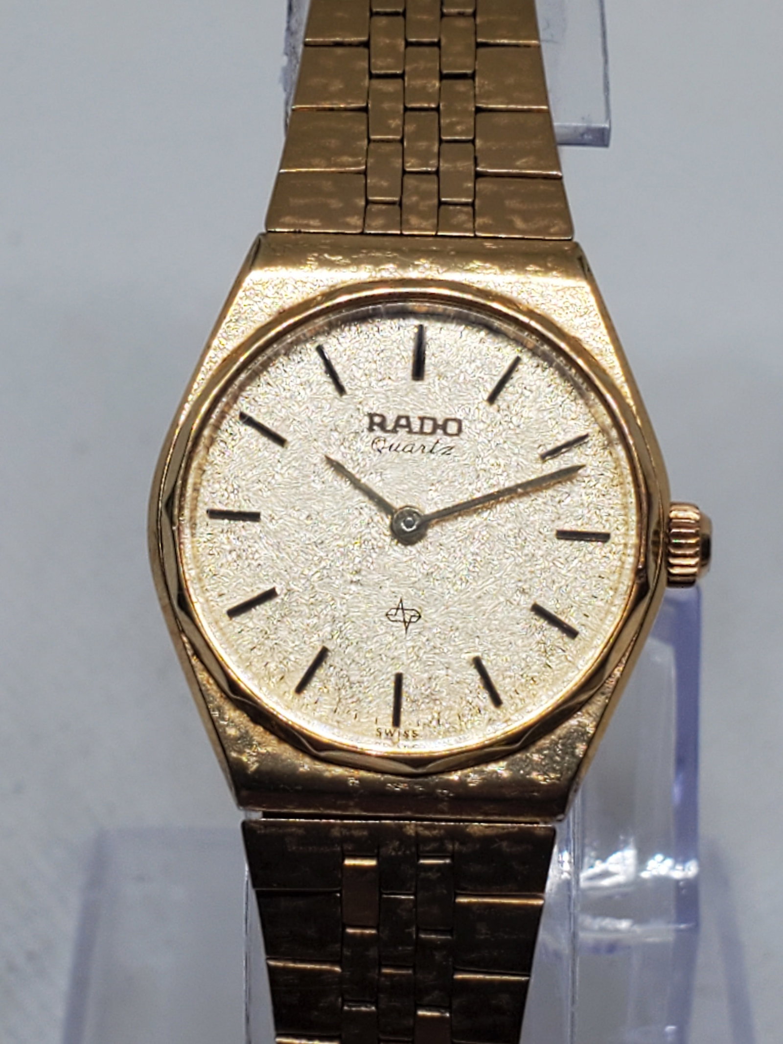 Vintage Rado 717.9011.2 Gold Plated Quartz Watch ? Frosted Dial Elegance, 1980s, Working: This exquisite vintage Rado Quartz 717.9011.2 showcases the timeless sophistication that defines the Rado legacy. Featuring a gold plated case and a captivating frosted gold tone dial, this piece radi