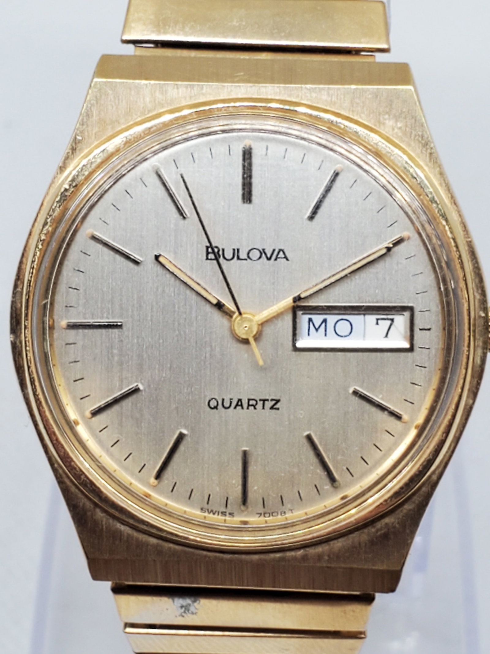 Vintage Bulova Quartz Gold Plated Day Date Watch Swiss 70081 ? Classic Elegance, 1979 to 1983,: This elegant Bulova Quartz watch embodies the timeless sophistication and precision that define the brand?s legacy. Featuring a gold plated case with a satin gold dial and refined stick hour markers, 