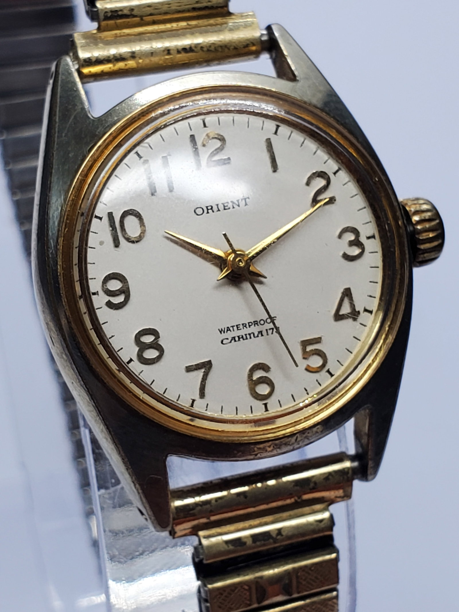 Orient Carina Manual Gold Plated 17 Jewels Dress Watch, 1962, Working: This elegant Orient Carina E471-51000 manual wind dress watch captures the refined simplicity and vintage charm that define mid century Japanese watchmaking. Featuring a gold plated case paired with a