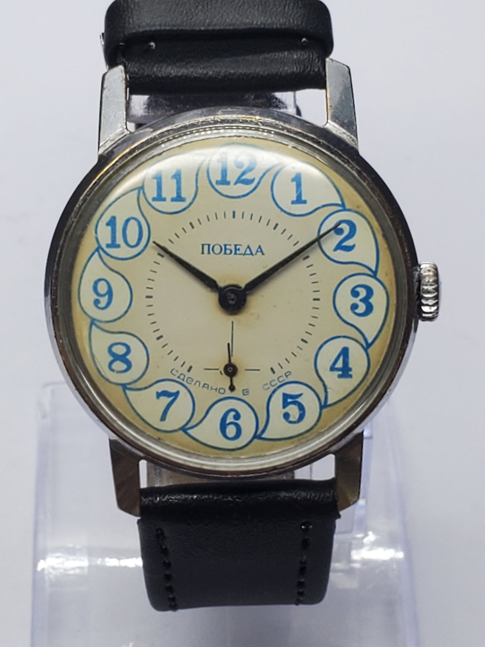 Pobeda 2602 Soviet Manual Watch Blue Numerals Sub Seconds USSR, 34mm, 1960s, Working: Own a charming piece of Soviet horological history with this vintage Pobeda 2602 manual wind watch, a collectible utility timepiece celebrated for its simplicity, reliability, and distinctive design. 