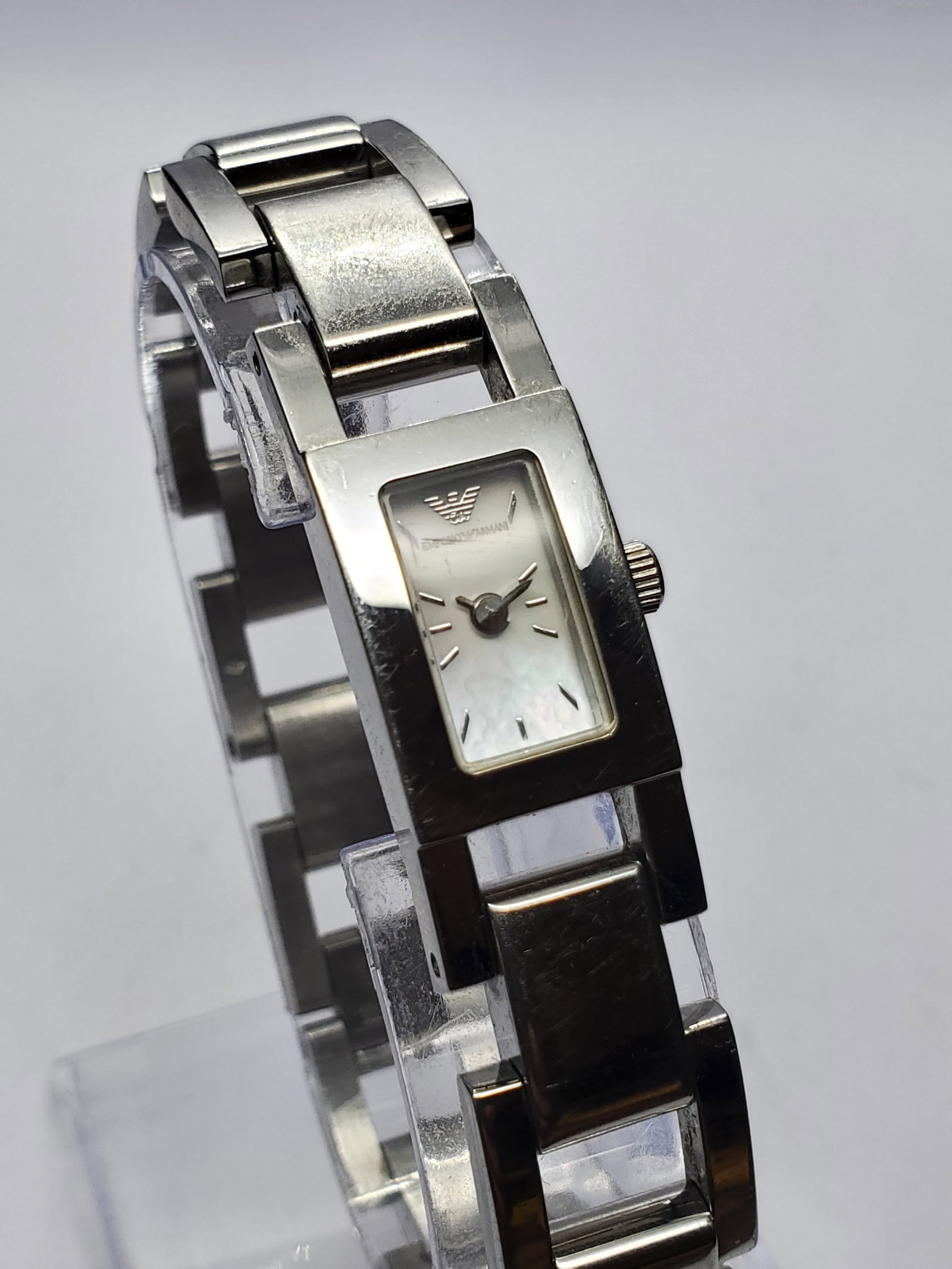 Emporio Armani AR5577 Mother of Pearl Silver Tone Watch, 13x19mm, 2010s, Working: Elegant Italian fashion meets refined modern watch design in this Emporio Armani AR5577 ladies dress watch, a sophisticated accessory from the celebrated fashion house founded by Giorgio Armani in 197