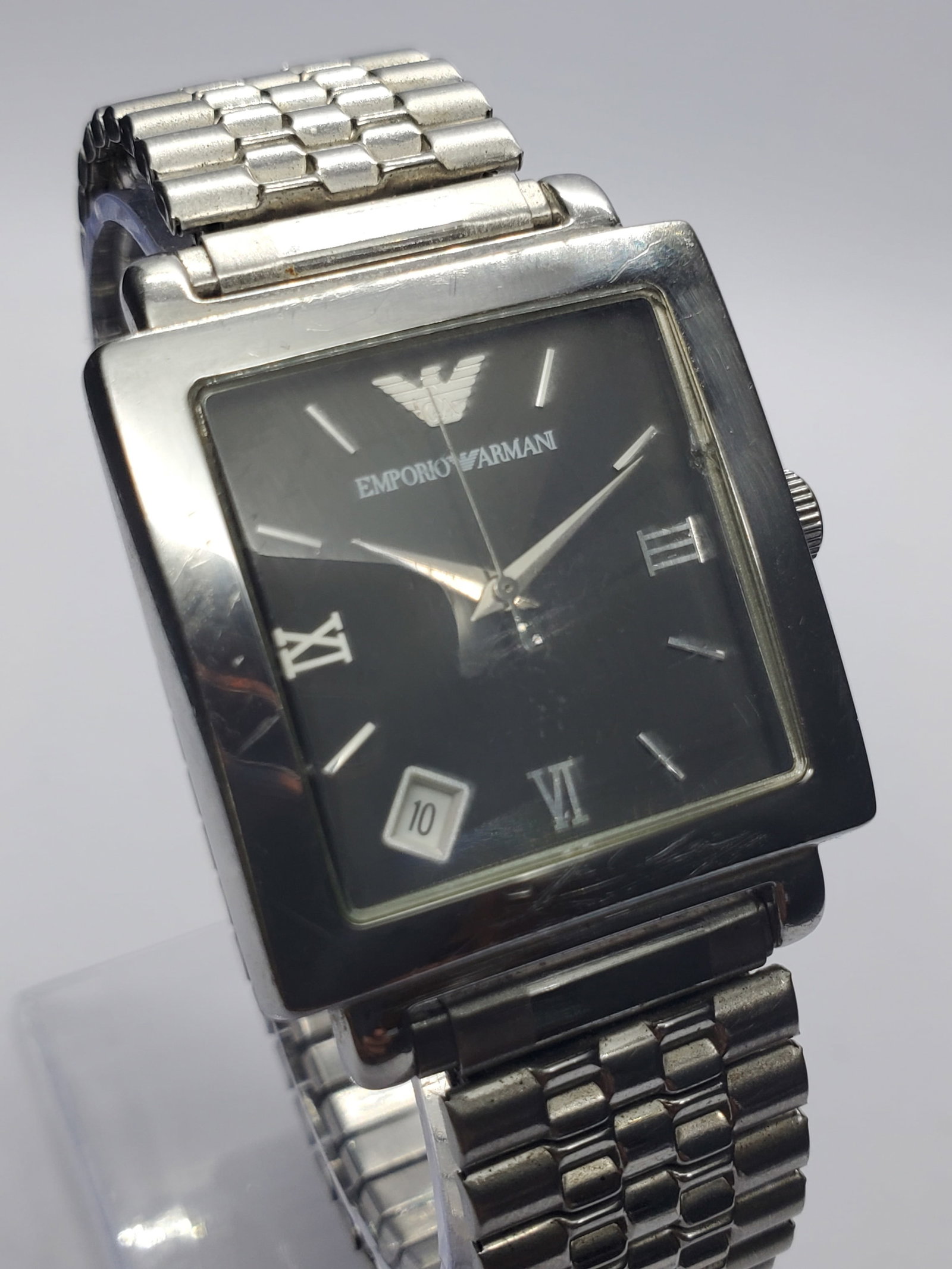 Emporio Armani Silver Tone Square Dress Watch, 30x30mm, 2010s, Working: Elevate your collection with this refined Emporio Armani AR5303 quartz dress watch, a sophisticated expression of Italian design heritage. Founded by Giorgio Armani in 1975 in Milan, the brand is cele