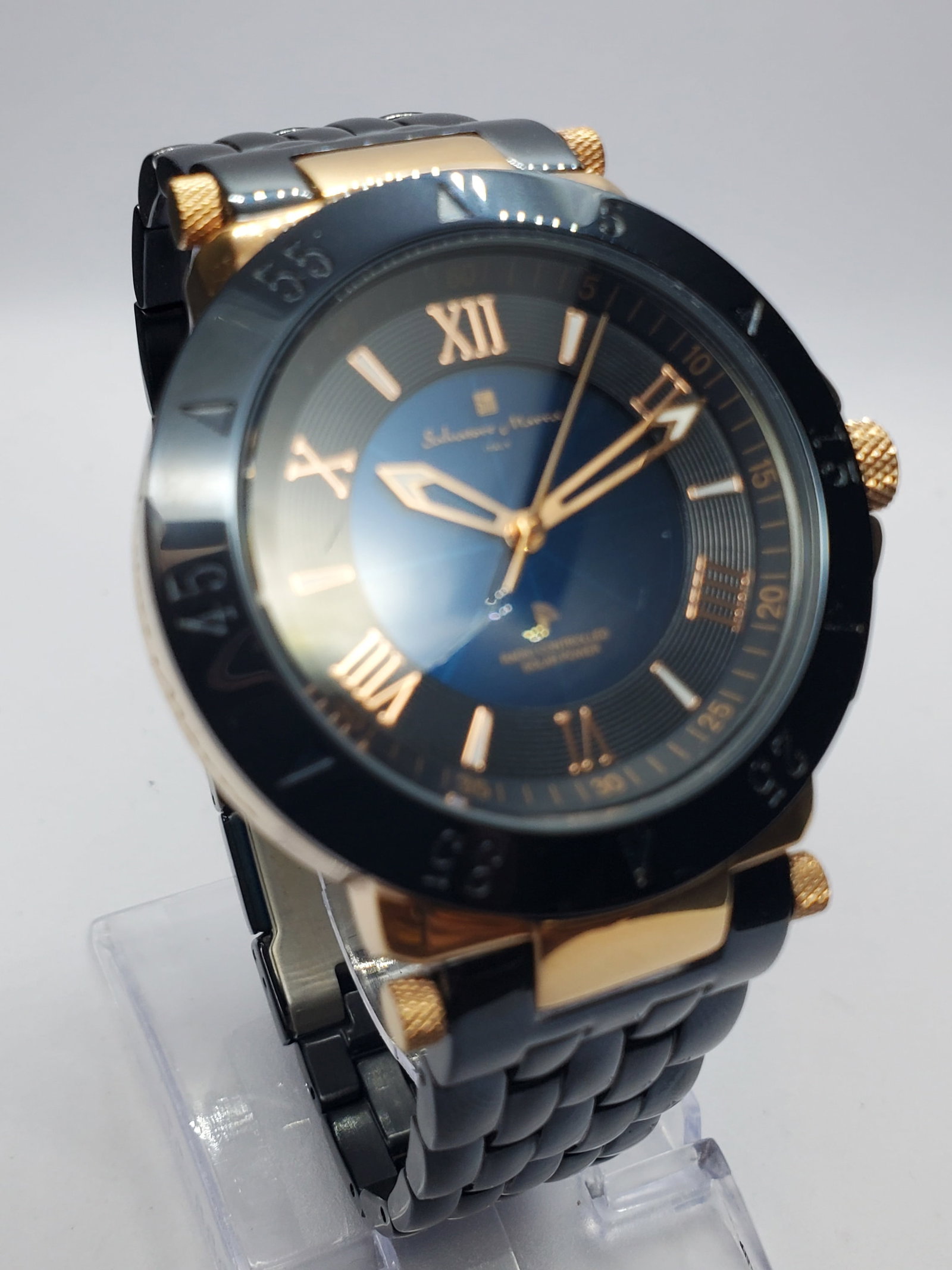Salvatore Marra 15th Anniversary Solar Blue Dial Watch, 42mm, 2010s, Running: Salvatore Marra SM18112 1 Special Edition 15th Anniversary Dress Watch featuring a rose gold tone case, black minute marked bezel, striking blue sunburst dial with concentric guilloch? pattern, applie