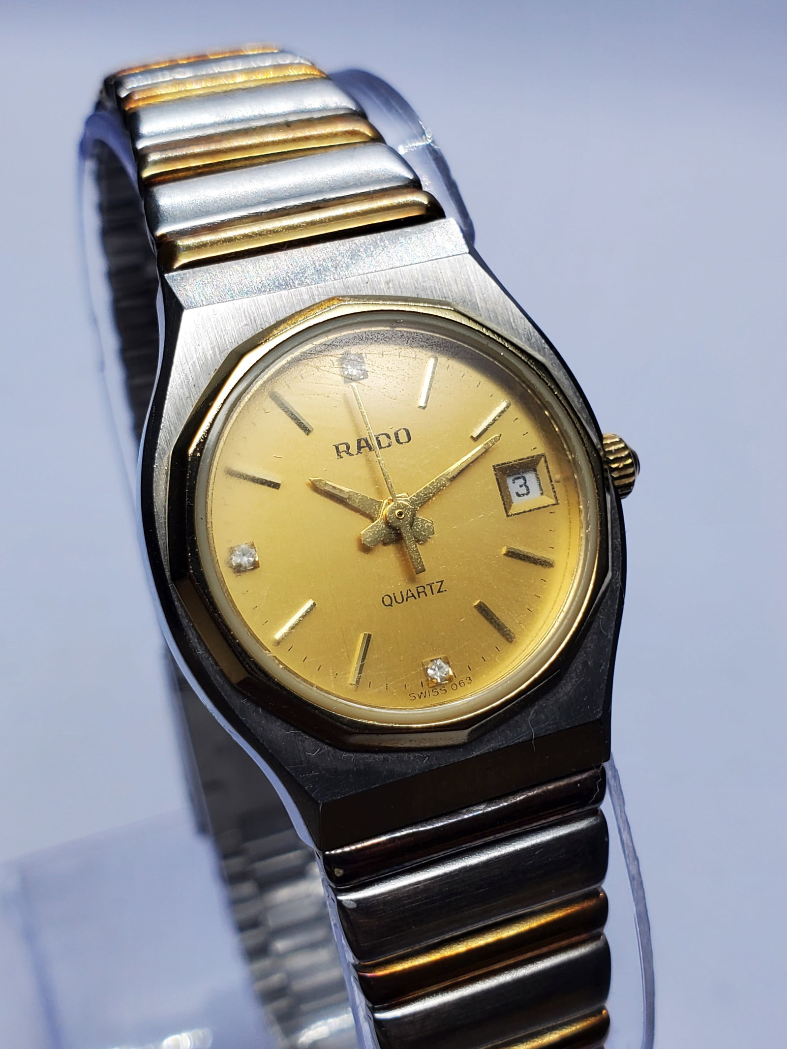 Vintage Rado Diamond Accent Gold dial Swiss Dress Watch, 24mm, 1980s, Running: Experience the refined elegance of this vintage Rado 111.4009.4 Swiss Quartz dress watch, a sophisticated timepiece from one of Switzerland?s most respected watchmakers. Founded in 1917 in Lengnau, Sw