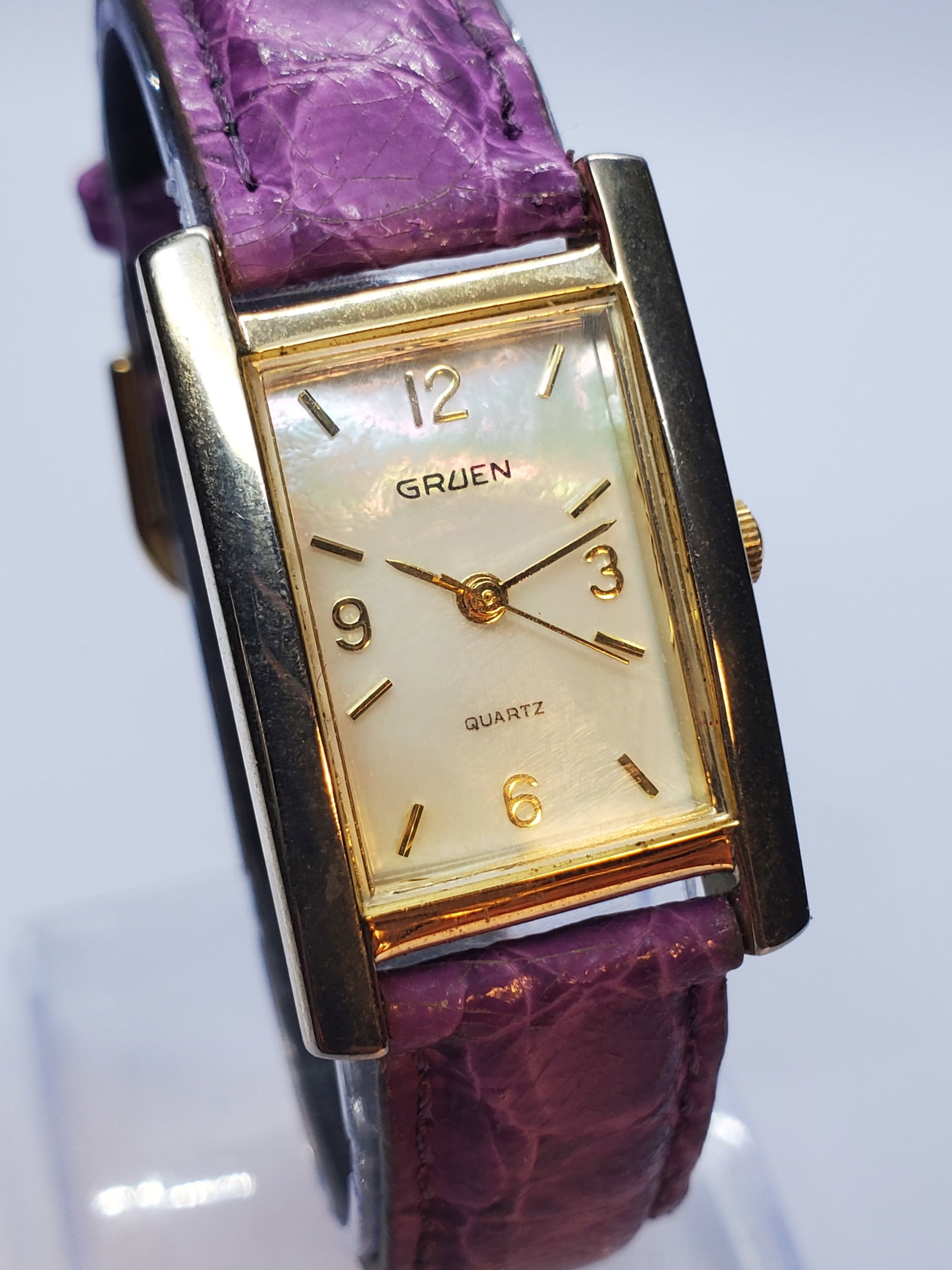 Vintage Gruen Mother of Pearl Dial Gold Tone Quartz Tank Watch, 1980s, Running: This elegant Gruen GR7969 quartz watch showcases refined vintage styling with a gold plated case framing a luminous mother of pearl dial that shifts beautifully under light, complemented by gold tone 