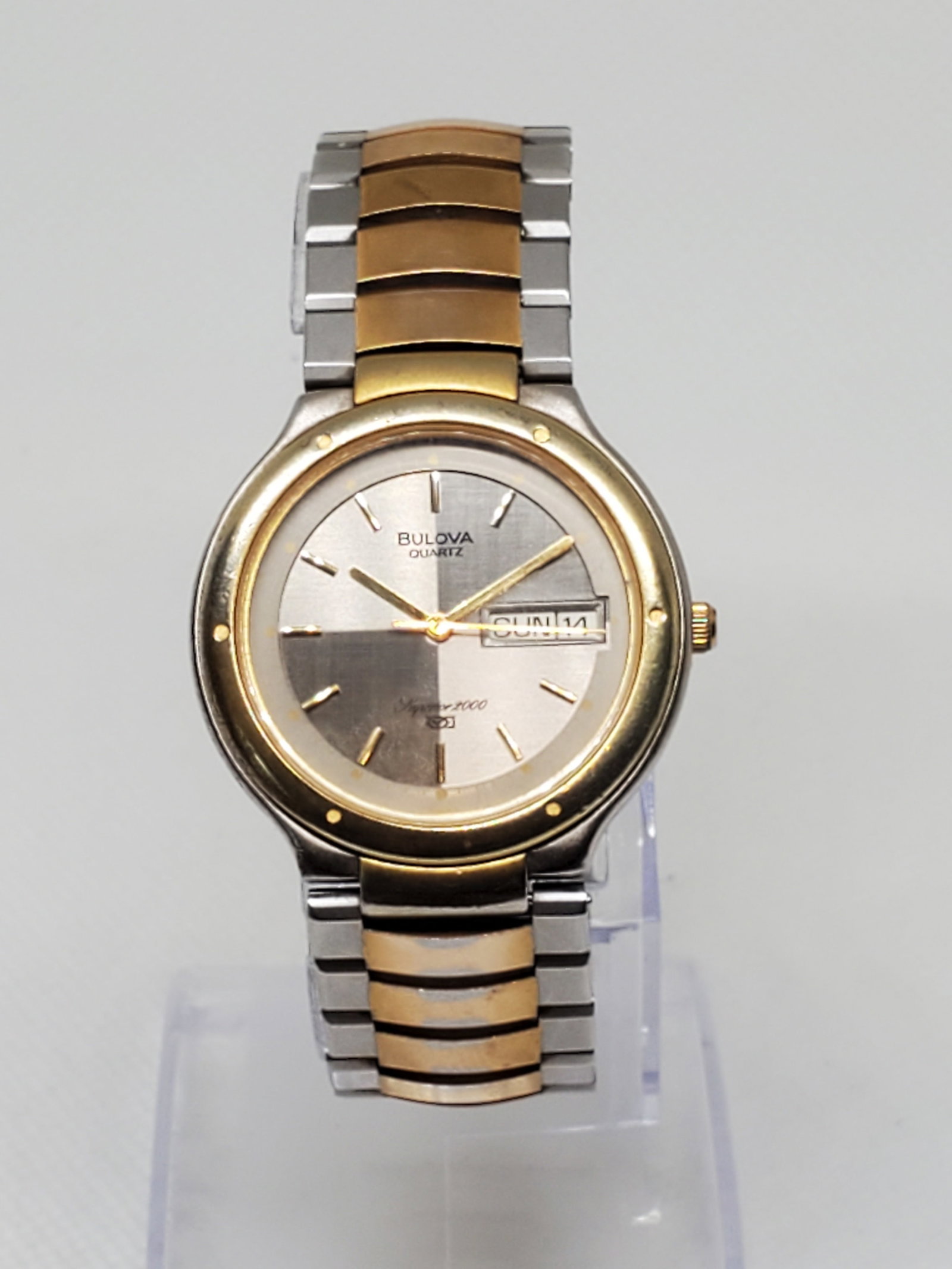 Vintage Bulova Superior 2000 Dual Tone Quadrant Dial Watch 33mm, 1980s, Running: Elegant Bulova Superior 2000 quartz dress watch featuring a dual tone stainless steel and gold plated case, alternating tone quadrant silver dial with gold markers, and practical day date display. Its