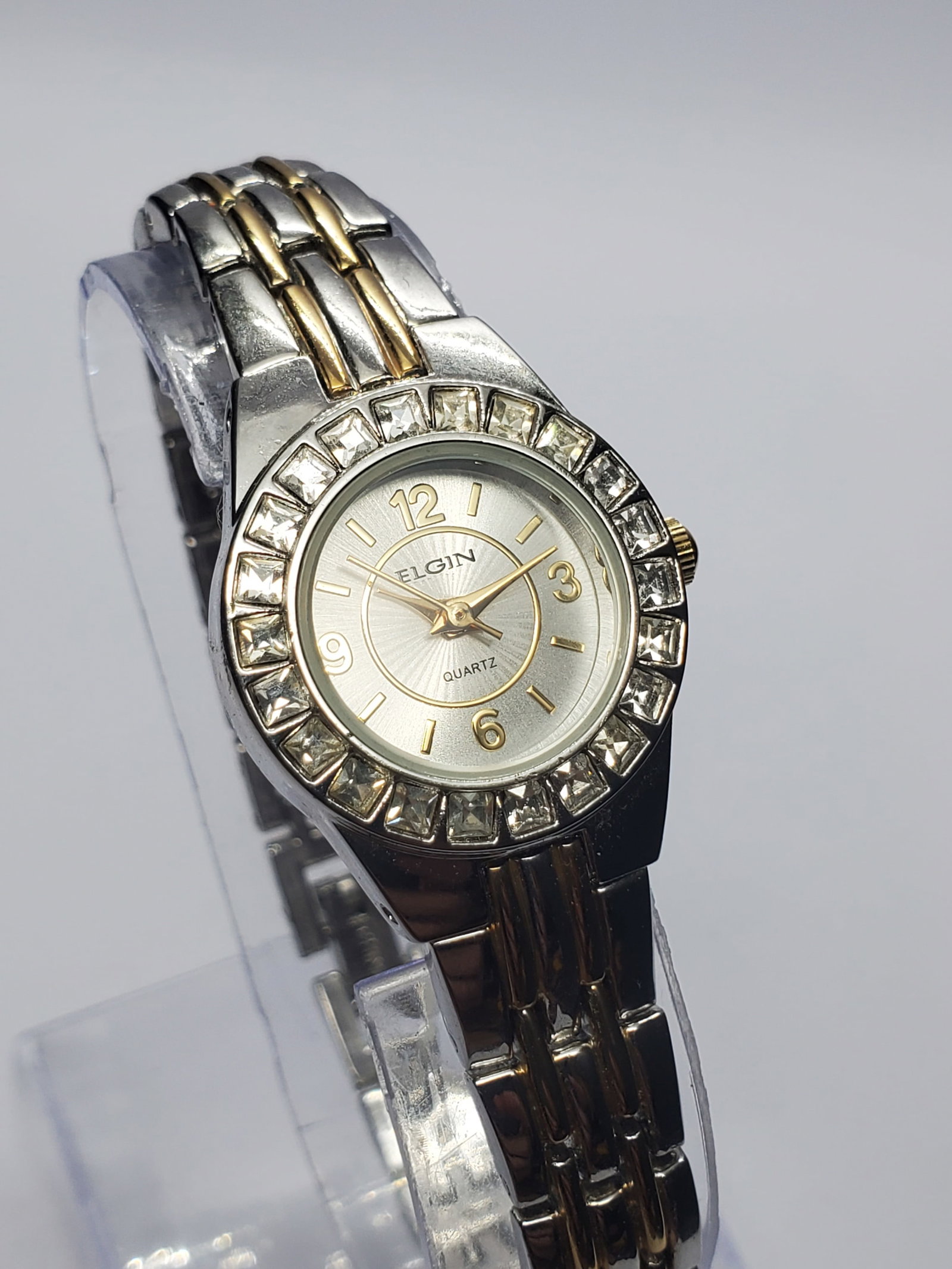 Vintage Elgin Crystal Bezel Quartz Dress Watch, 23mm, 2000s, Running: Add timeless elegance to your collection with this vintage Elgin EG8073ST quartz dress watch featuring a polished silver tone case, sparkling crystal set bezel, and a refined sunburst silver dial acce