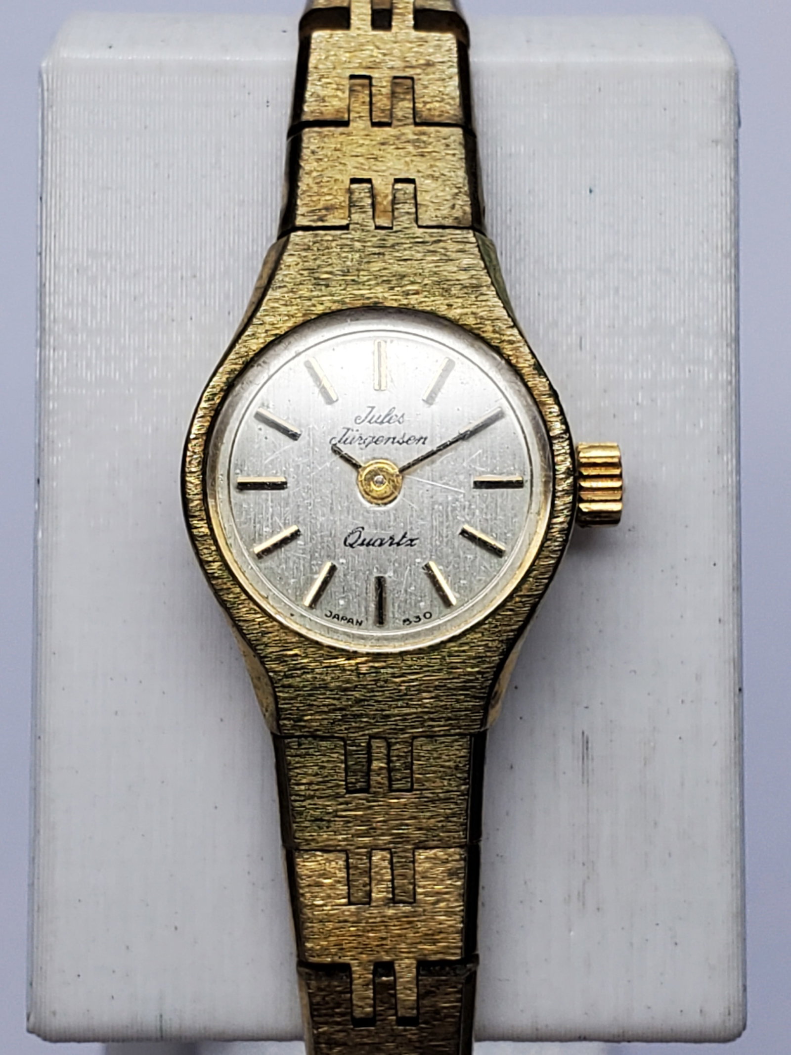 Vintage Jules Jurgensen Gold Tone Ladies Dress Watch, 16x20mm, circa 1990, Running: Elegant and timeless, this vintage Jules Jurgensen 6025 quartz dress watch features a refined gold tone case, clean silver dial, and an integrated gold tone bracelet measuring 6 inches, making it a so