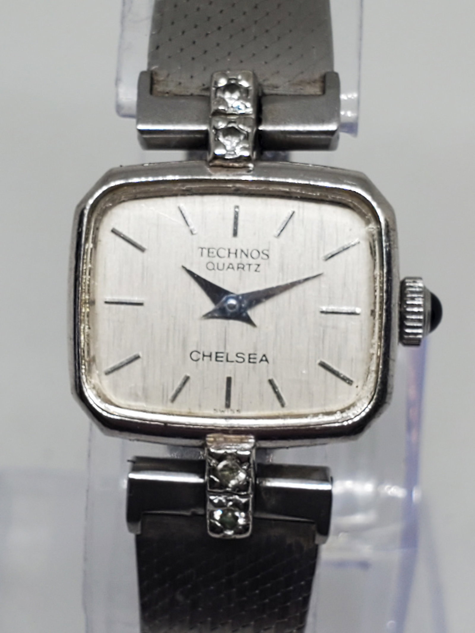 Vintage Technos Chelsea Quartz Womens Watch w/ Diamonds, 1970s, Running: This elegant Technos Chelsea womens watch, reference 709020, combines timeless sophistication with the reliable performance of Swiss quartz craftsmanship. Featuring a silver tone case and a brushed si