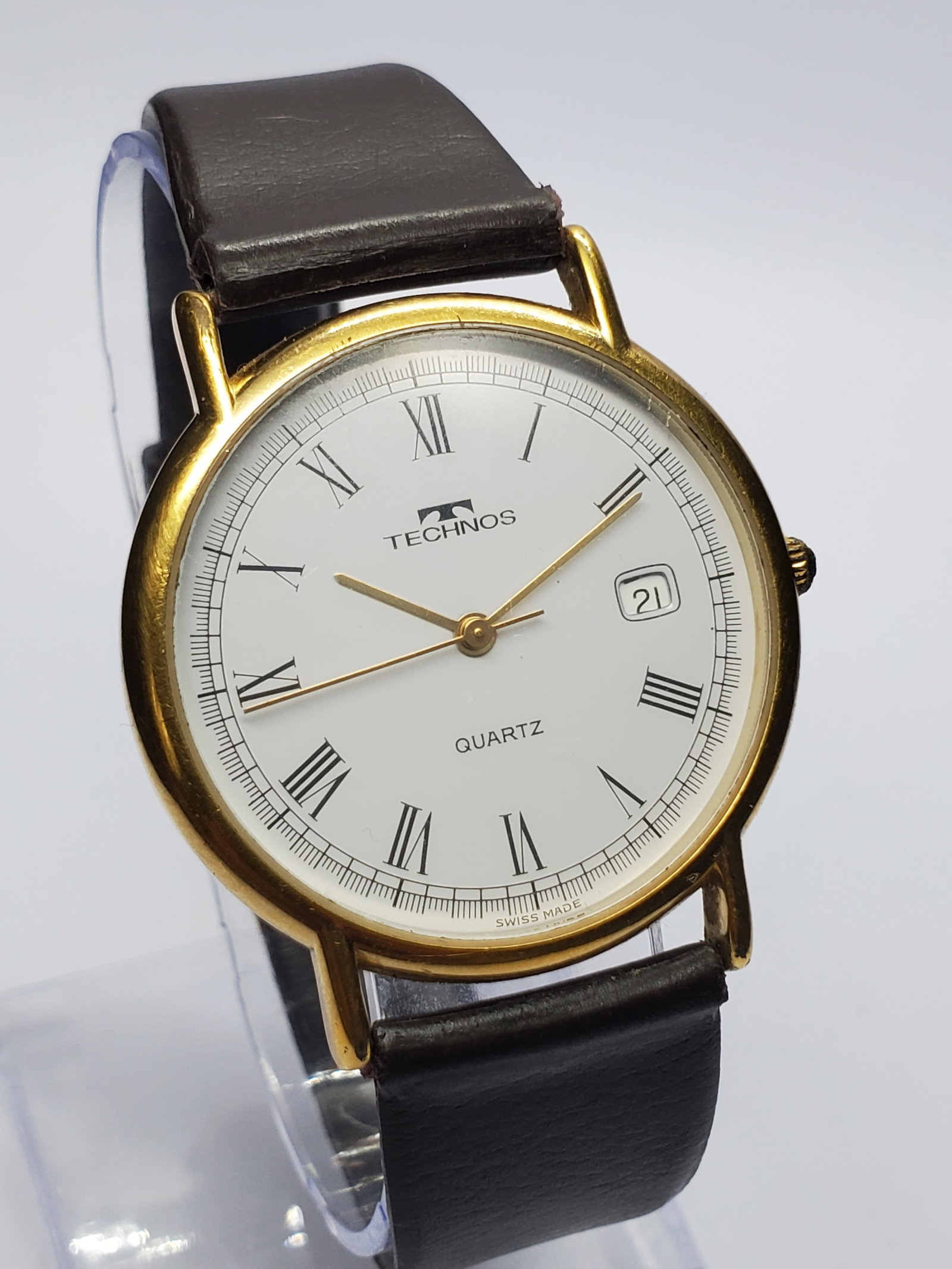 Vintage Technos Gold Plated Swiss Quartz Watch, 34mm, 1990s, Running: Add timeless Swiss elegance to your collection with this Technos A1901Z quartz dress watch, a refined vintage timepiece blending classic styling with dependable practicality. Founded in 1900 in Wilsdo