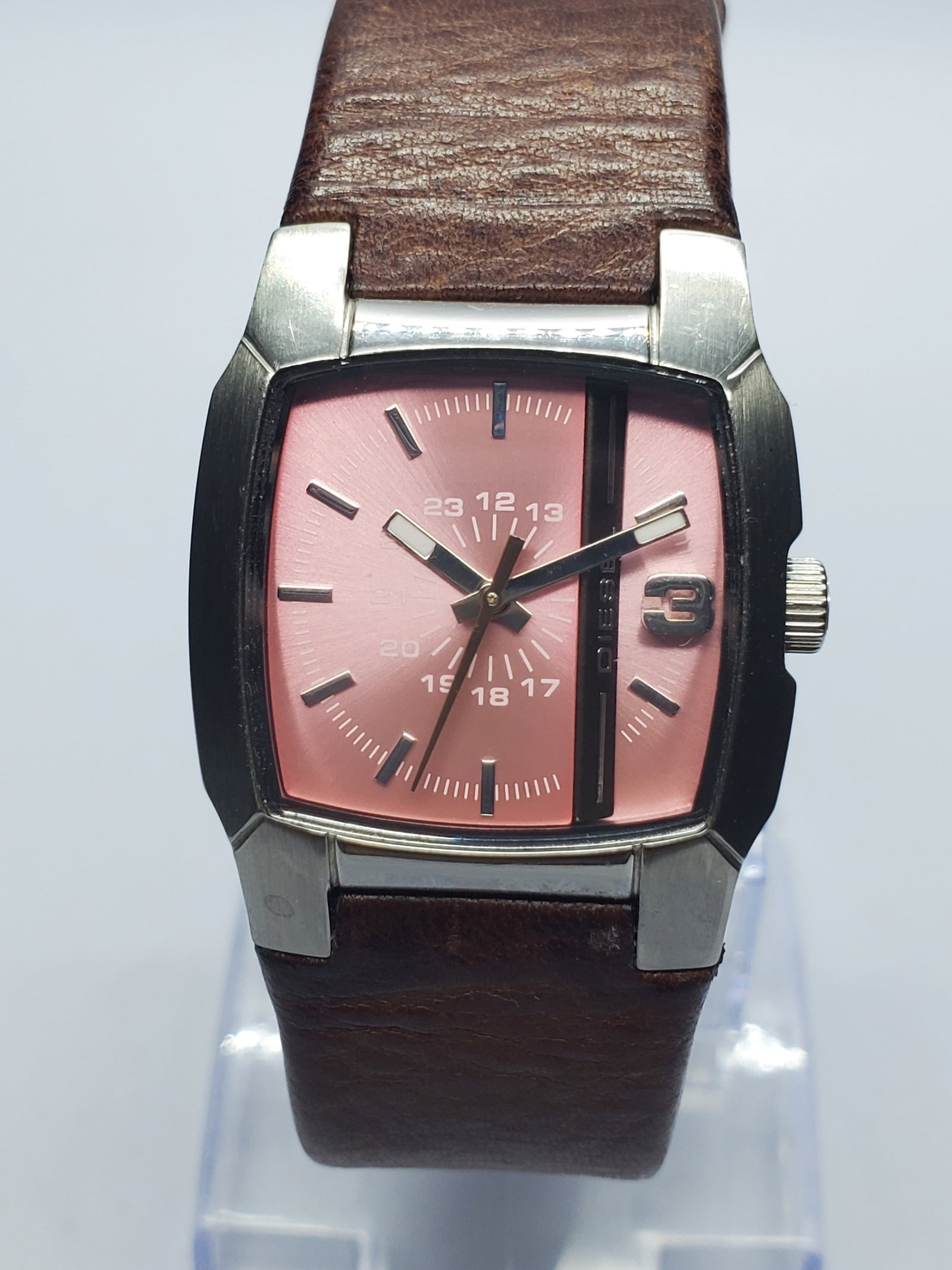 Diesel Pink Dial Quartz Watch, 28x27mm, 2010s, Running: Bold yet elegant, this Diesel DZ5335 women?s quartz dress watch pairs a silver-tone 28 x 27 mm case with a metallic pink dial, silver-tone markers, an inner 24-hour scale, and a distinctive raised num
