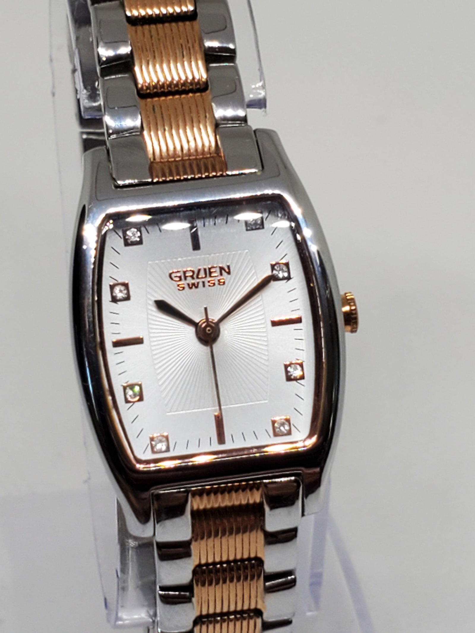 Vintage Gruen Dual Tone Rose Gold Silver with Crystals Tank Watch, 2000s, Running: Discover the timeless elegance and luxury of the Gruen GLS128 Running a refined timepiece that radiates sophistication with its exquisite rose gold and silver tones. The contrast between the rose gold
