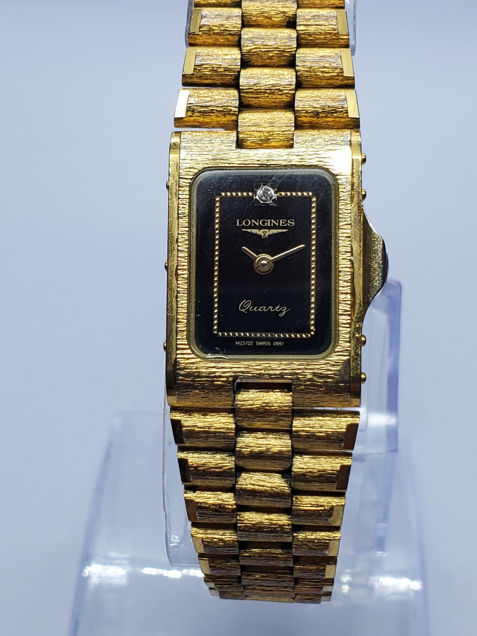 Vintage Longines MZ5722 Gold Tank Quartz Watch, 17x25mm, 1980s, Running: Elegant vintage Longines MZ5722 ladies dress watch featuring a petite 17 mm x 25 mm gold-plated tank case, brushed gold bezel, black dial with refined gold details, and a clear stone accent at 12 o?cl