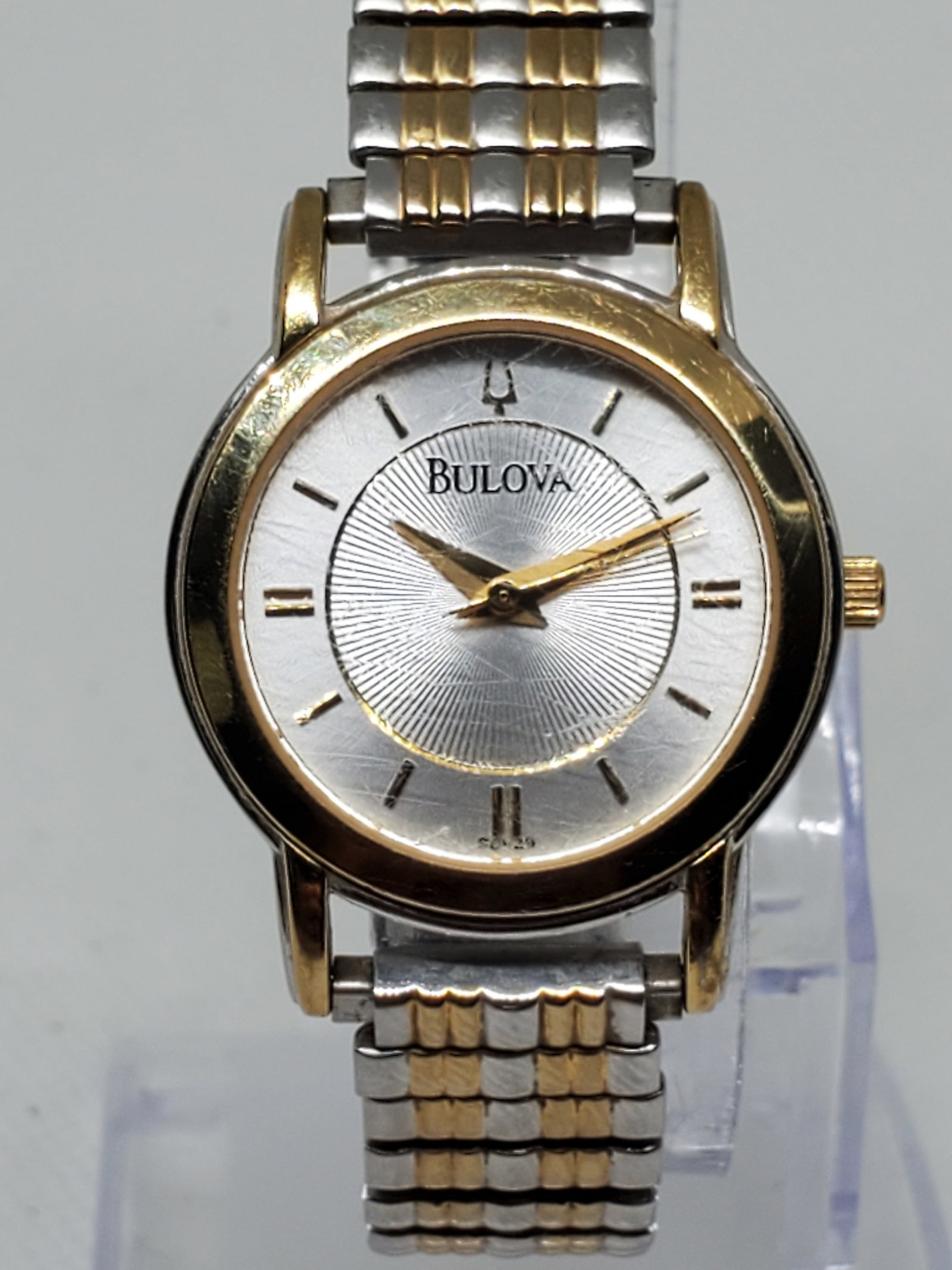 Vintage Bulova Gold Plated ladies Watch, 1997, Running: Elevate your wristwear with the Bulova C976836, a refined dress watch that blends elegance and practicality. This quartz timepiece features a silver tone rectangular case accented by a gold plated bez