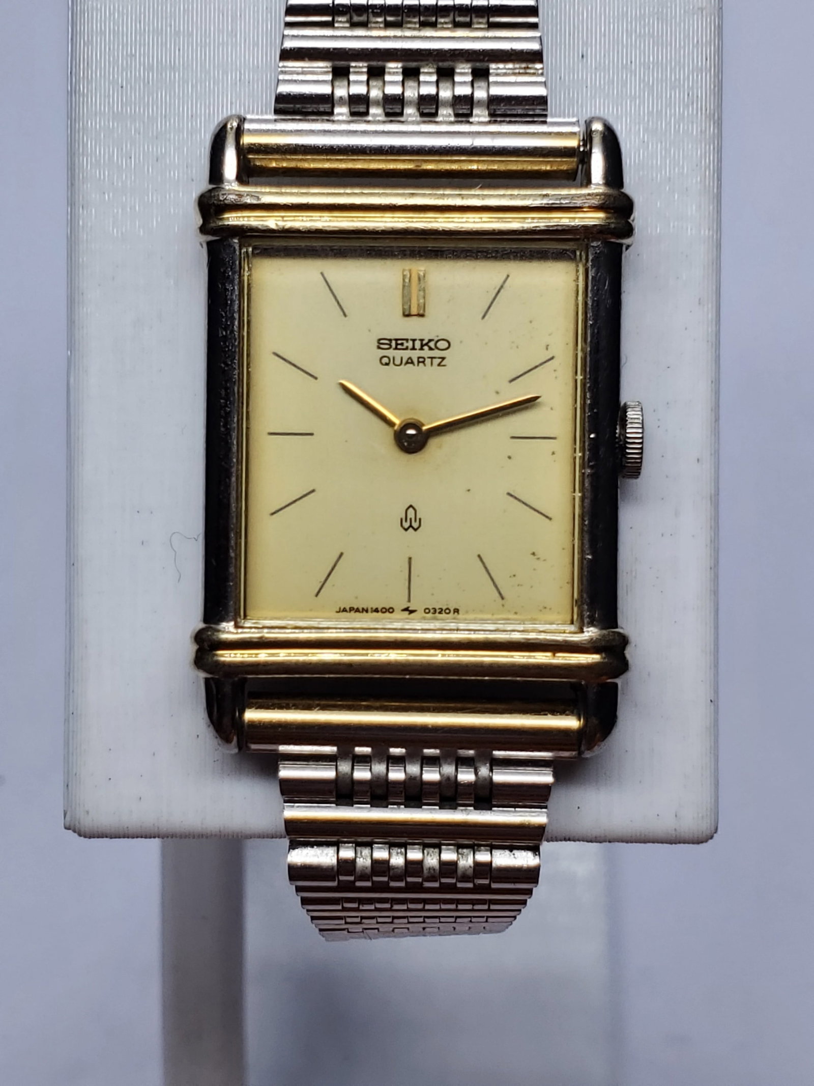 Vintage Seiko Tank Dual Tone Gold Plated Quartz Dress Watch, 19x21mm, 1991, Running: This elegant vintage Seiko 1400-524A quartz dress watch showcases refined minimalist design in a compact 19 mm by 21 mm rectangular case, featuring a sophisticated dual tone silver and gold finish tha