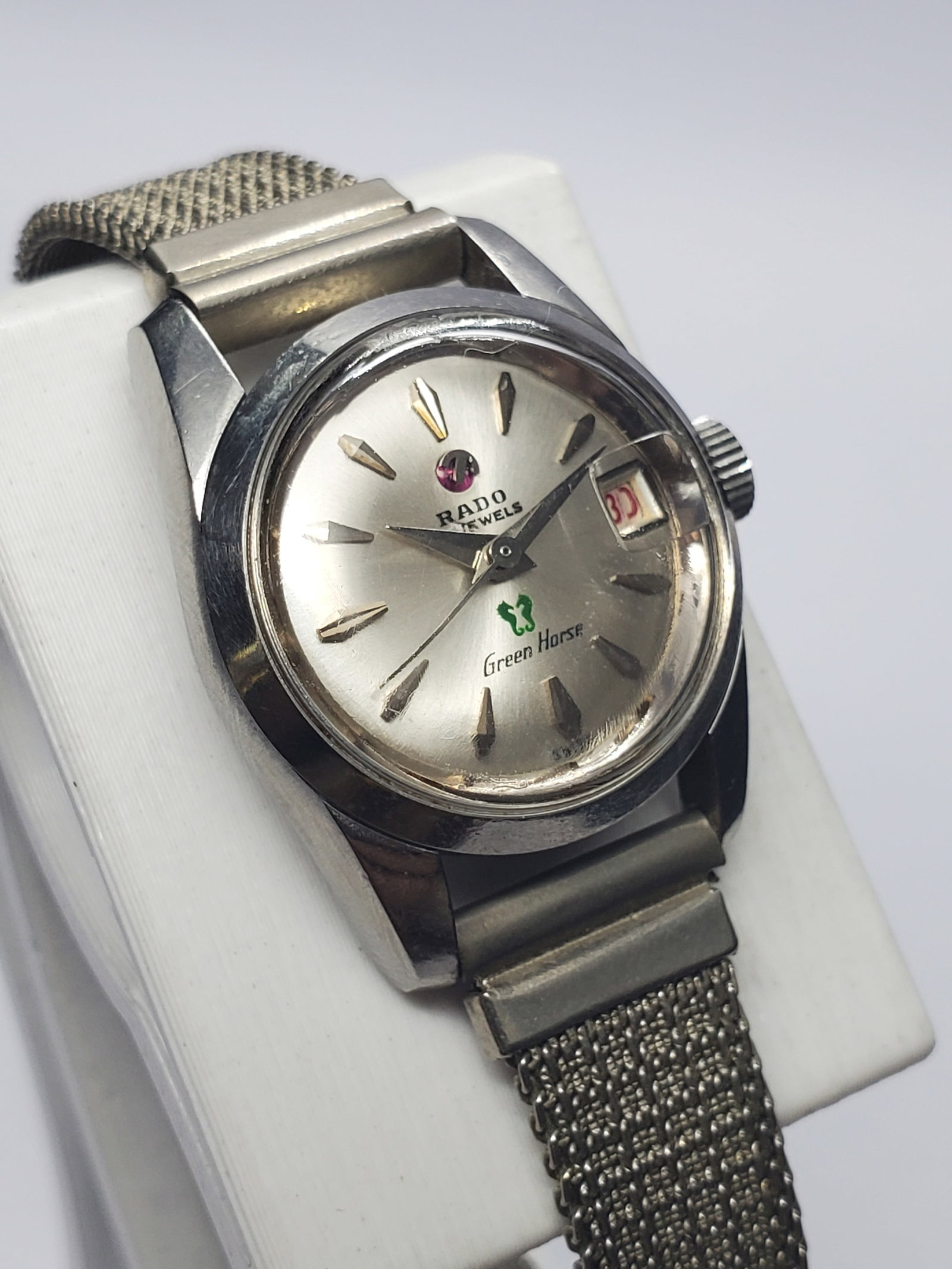 Vintage Rado Green Horse 759 Automatic Date Watch, 21mm, 1960s, Running: Experience classic Swiss elegance with this vintage Rado Green Horse 759 ladies? dress watch, featuring a compact 21 mm silver-tone case, silver sunburst dial, applied faceted markers, red date displa