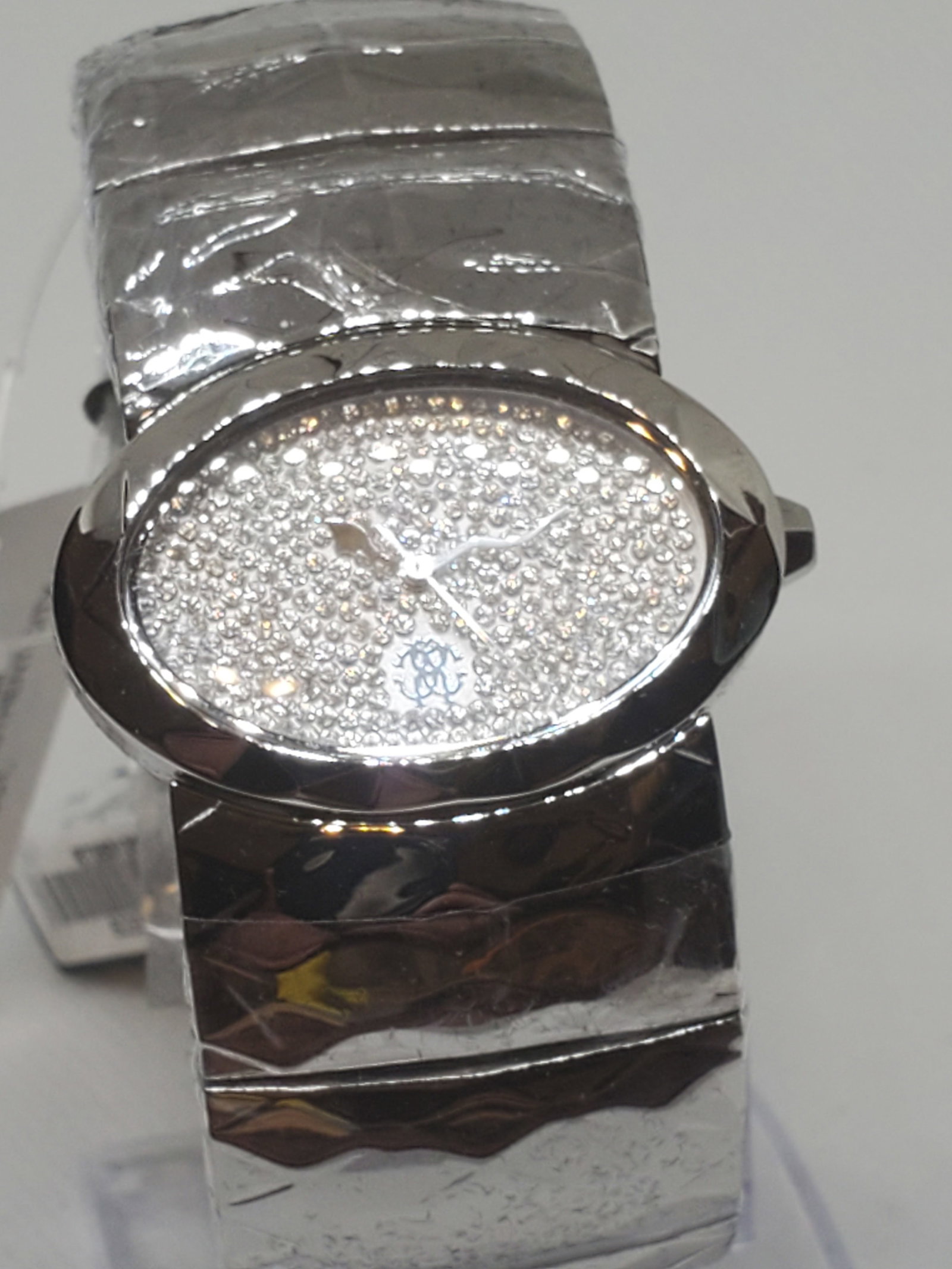 Vintage Roberto Cavalli Watch New Wrapped with Box, Running: Running condition the Roberto Cavalli R7253133615, a watch that epitomizes luxury and sophistication. Its silver tone oval dial, adorned with shimmering rhinestones, exudes a refined elegance that per