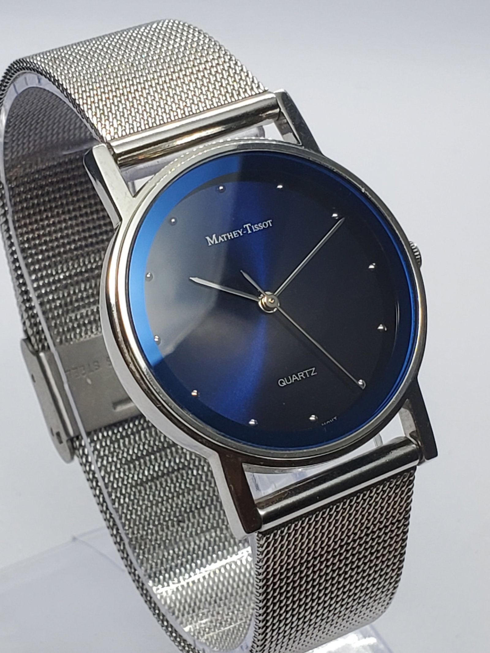 Vintage Mathey-Tissot Cobalt Blue Sunburst Watch, 32mm, 1990s, Working: Vintage Mathey-Tissot MT508 quartz dress watch featuring a polished silver-tone 32 mm case and a striking deep midnight-blue sunburst dial with a metallic finish that shifts toward vivid cobalt under 
