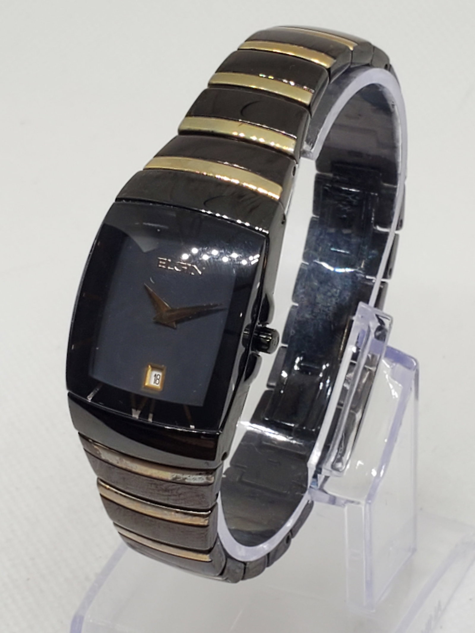 Vintage Elgin EG543 Black Gold Dress Watch Japan, 34mm, late 1990 to early 2000s, Running: This elegant Elgin EG543 wristwatch combines timeless sophistication with modern craftsmanship. Featuring a sleek black rectangular case and matching dial accented by gold tone hands and hour markers,