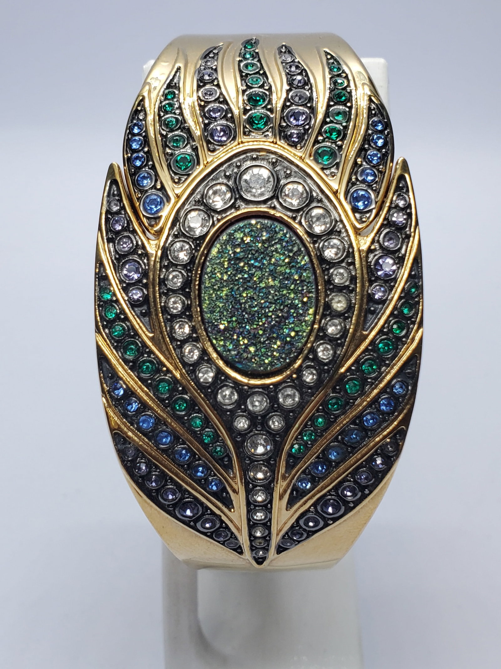 Victoria Wieck Peacock Feather Crystal Cuff Watch, 34x60mm, 2000s, Running: Make a dramatic statement with this Victoria Wieck Beverly Hills B8124 quartz dress watch, featuring a gold-tone case concealed beneath an ornate peacock-feather cuff decorated with green, blue, laven