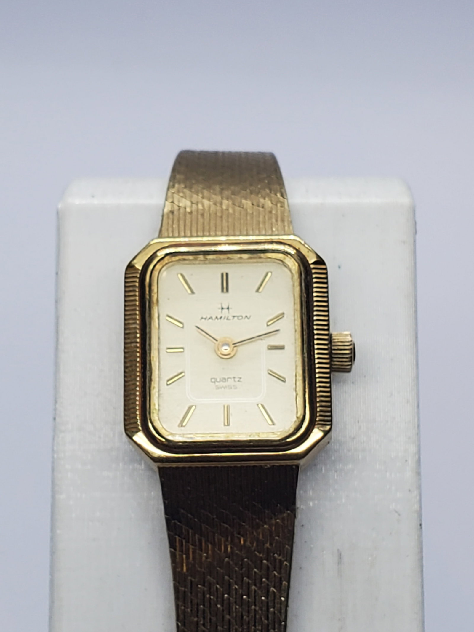 Vintage Hamilton 8488 Gold-Plated Tank Quartz Ladies Watch, 16x18mm, 1980s, Running: This elegant vintage Hamilton Model 8488 ladies? dress watch brings refined prestige to a petite, jewelry-like design. Its 16 x 18 mm gold-plated tank case frames a gold dial with matching gold marker
