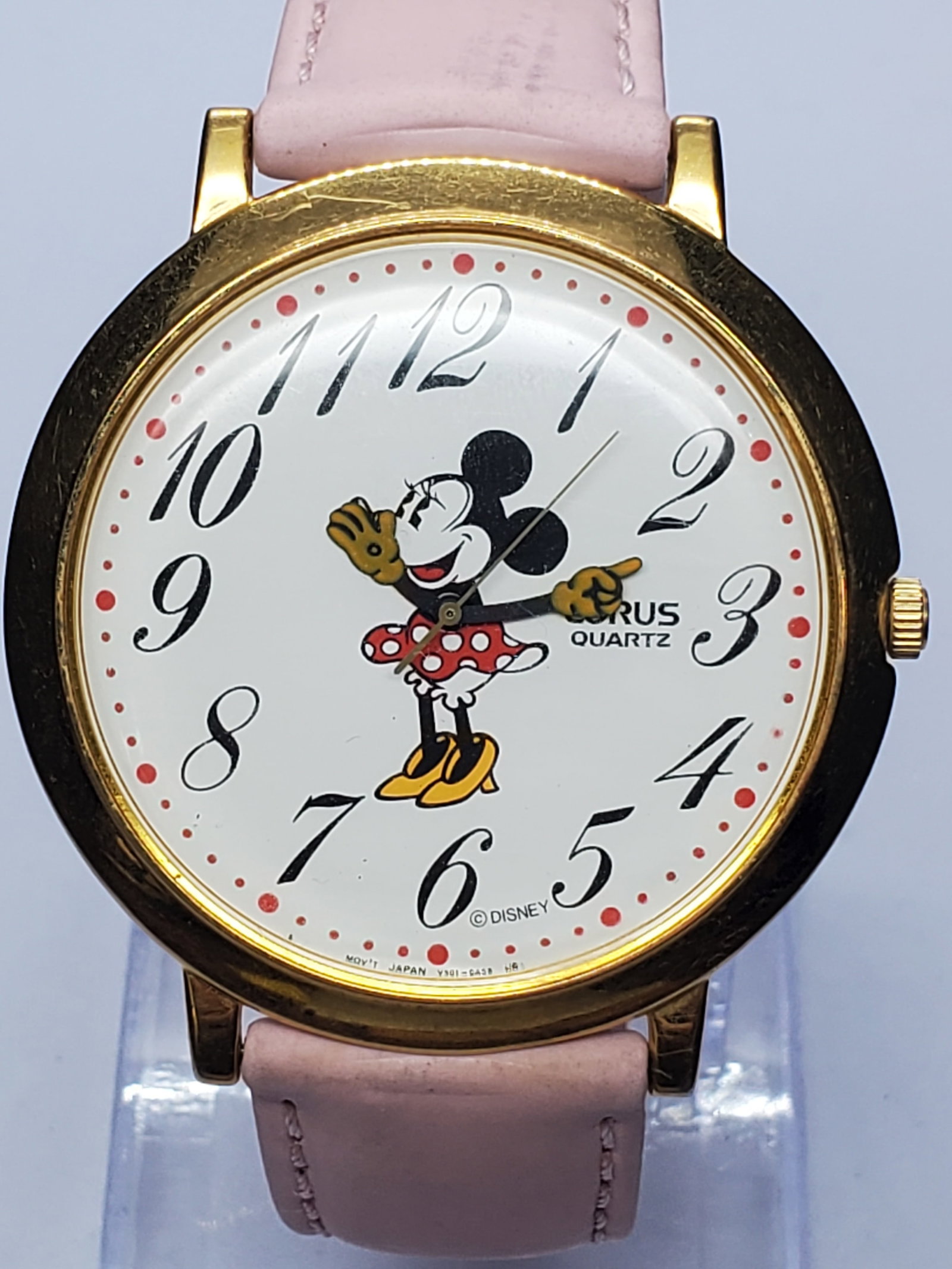 Vintage Seiko Lorus Minnie Mouse Gold Plated 44mm, 1990s, Running: This charming Seiko Lorus V501-A020 Quartz watch captures both elegance and nostalgia with its delightful Minnie Mouse design on a crisp white dial. Featuring a gold-plated case and a bold 44mm size, 