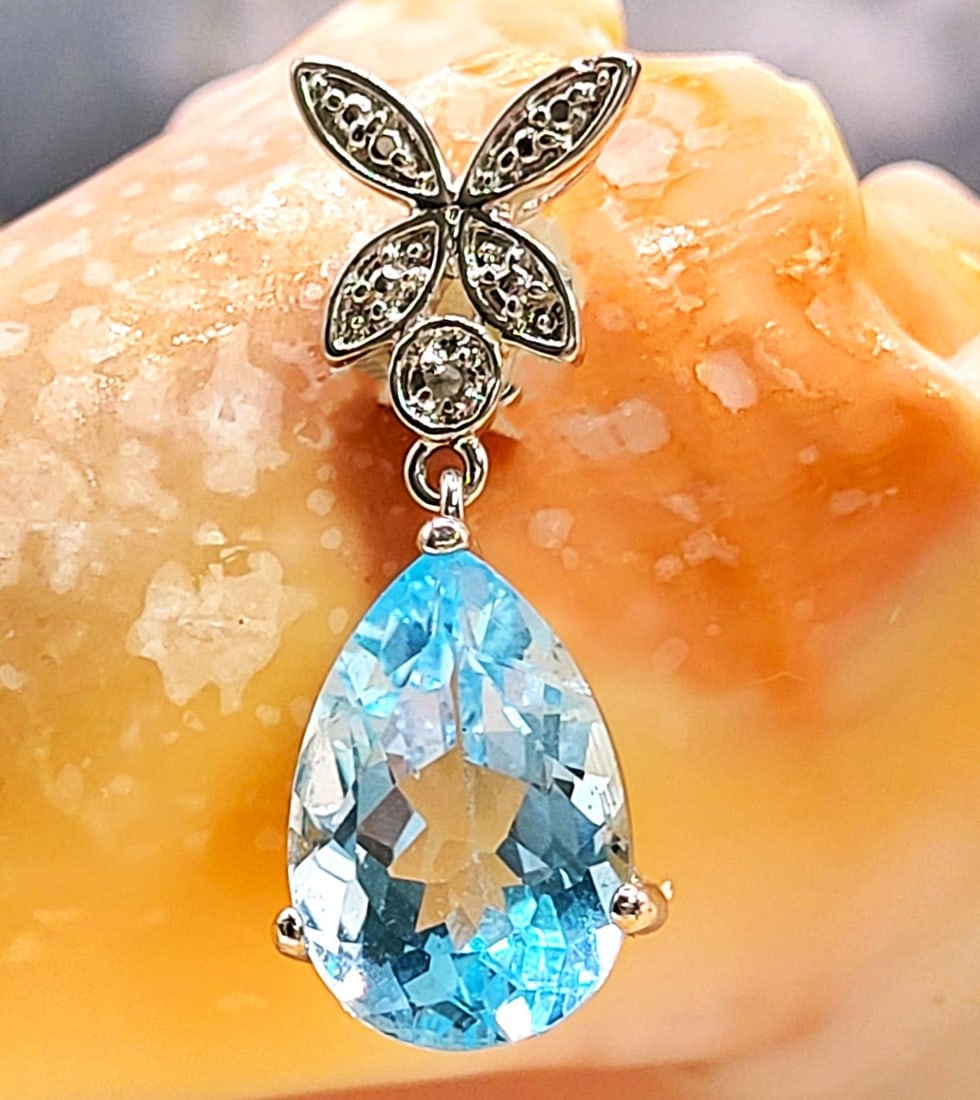 Swiss Blue Topaz & Diamond Butterfly Drop Pendant: Setting: Sterling Silver .925 Main Gemstone: Genuine Blue Topaz Adjacent Gemstone: Genuine, Natural Accent Diamond Hallmark/Designer: DBJ-Jasco Designs (since 1990, NY) This STERLING SILVER pendant fe
