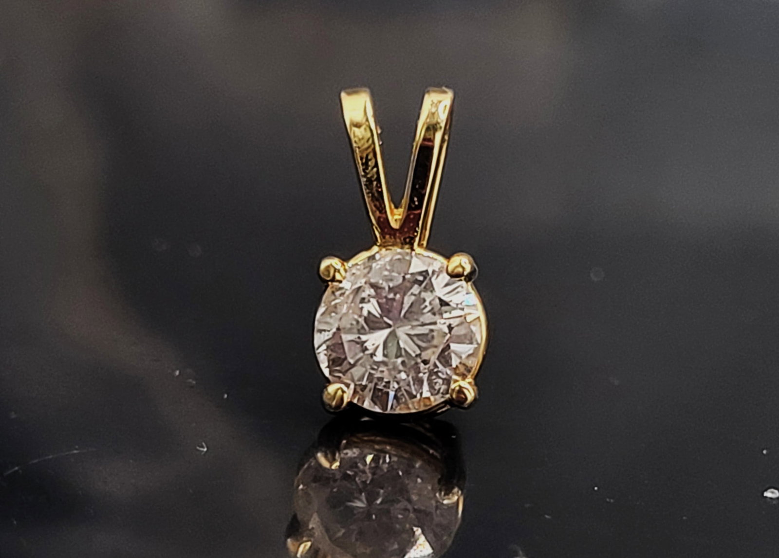 Diamond Pendant -The Quintessential Jewelry Item: Setting: 14K Yellow Gold Main Gemstone: Genuine, Natural Diamond A diamond solitaire pendant is almost "mandatory" for every woman's armoire! This is a 14 karat yellow gold pendant that features an ap