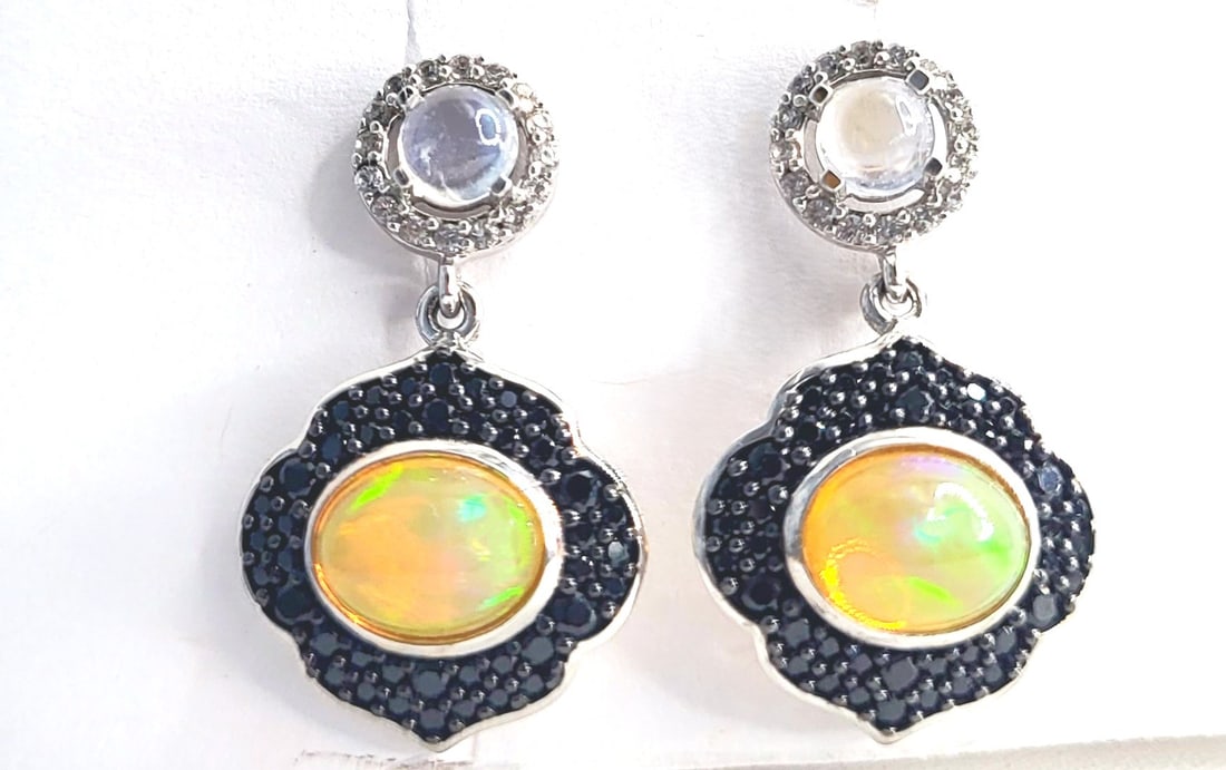 Ethiopian Opal, Moonstone & More Dangle Earrings: Setting: Sterling Silver .925 Primary Gemstone: Genuine Ethiopian Opal Secondary Gemstone: Genuine Black Spinel Additional Gemstone: Genuine Rainbow Moonstone and Genuine Whi