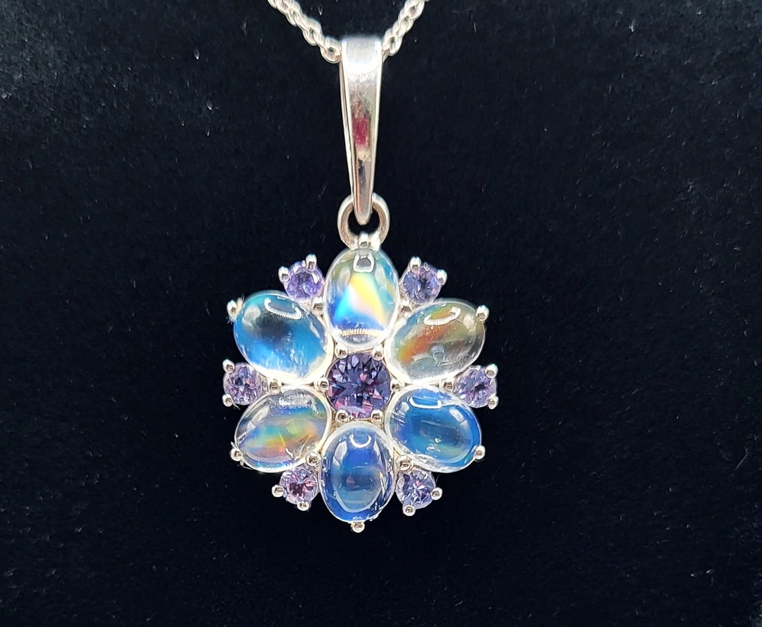 Rainbow Moonstone and Tanzanite Necklace: Setting: Sterling Silver .925 Primary Gemstone: Rainbow Moonstone Secondary Gemstone:Tanzanite (Zoisite) Link Style: Fine, Open Link Closure: Spring Ring Length: 18" This sterling silver necklac