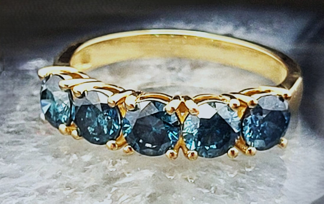Enchanting Genuine Blue Diamond Band, Ring 1.83CTW: Setting: 14K Yellow Gold Main Gemstone: Genuine, Natural, Blue Diamond* Size: 7 US Weight: 2.86 grams Blue diamonds form four times deeper in the earth than other diamonds and are blue due to traces o