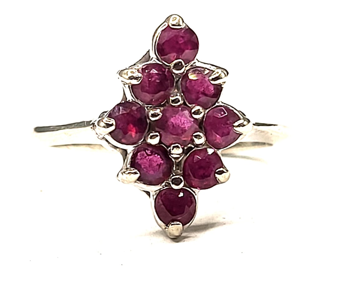Nostalgic Navette Ruby Cluster Ring: Setting: 14K White Gold Primary Gemstone: Genuine Ruby Size: US 7 Weight: 3.58g This 14 karat white gold ring with approximately 1.00 carat total weight of round, faceted genuine rubies that are prong