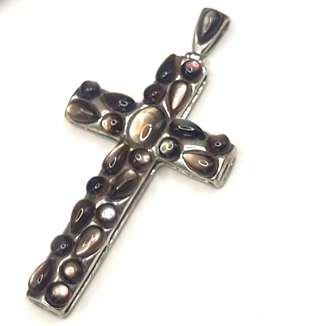 Cobblestone-esque Abalone Cabochon Cross Pendant: Setting: Sterling Silver .925 Primary Gemstone: Abalone Shell Dimensions: 2" x 1" Weight: 6.56g This sterlng silver pendant is quite stunning with polished cabachon abalone shells