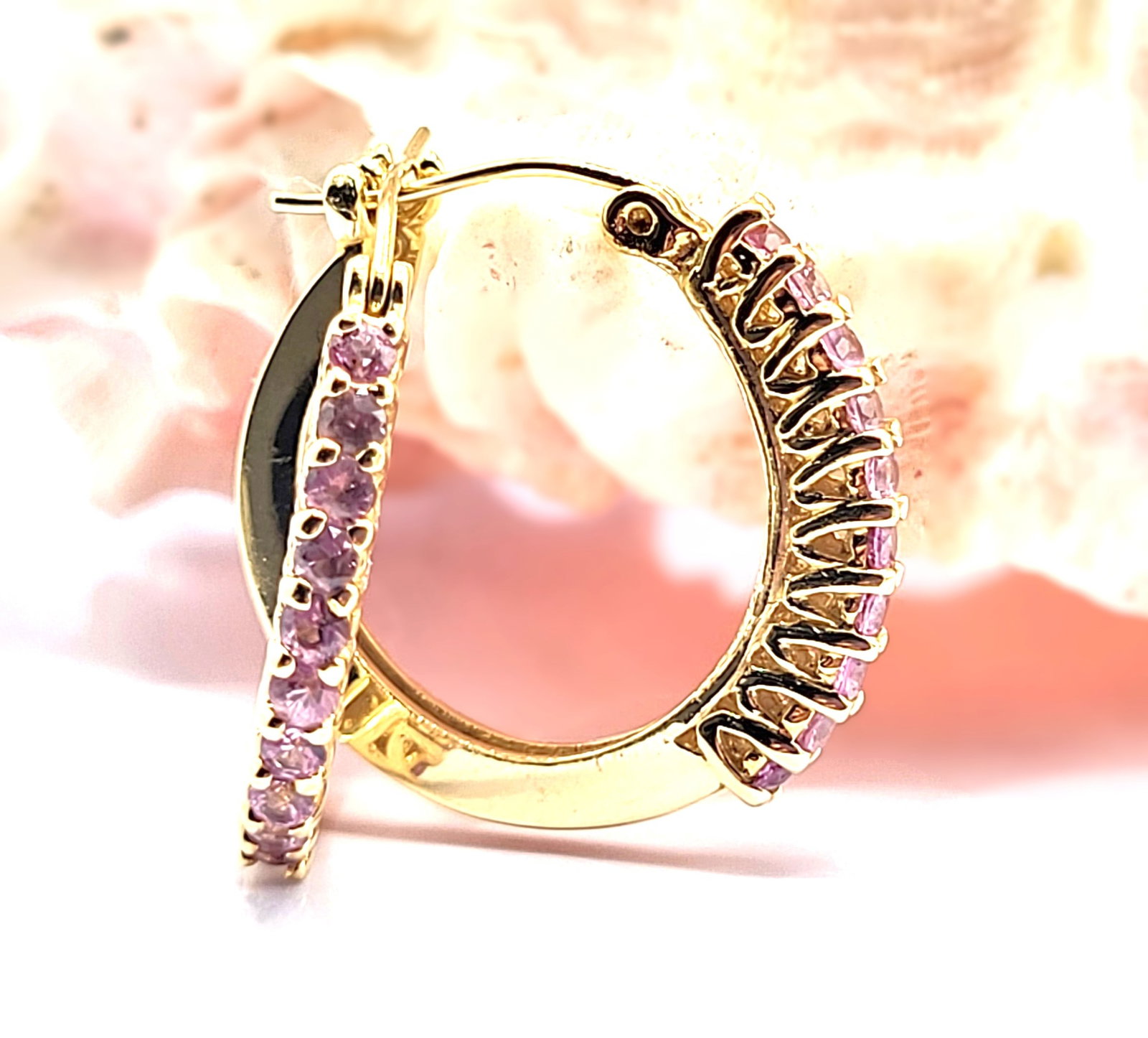 14K Yellow Gold 3/4" Pink Sapphire Hoops: Setting: 14K Yellow Gold Main Gemstone: Genuine Pink Sapphire Closure: Hinged Post with Snap-In Lock Diameter: 3/4" What a great pair of earrings for everyday wear! They are a modest size, at 3/4" dia