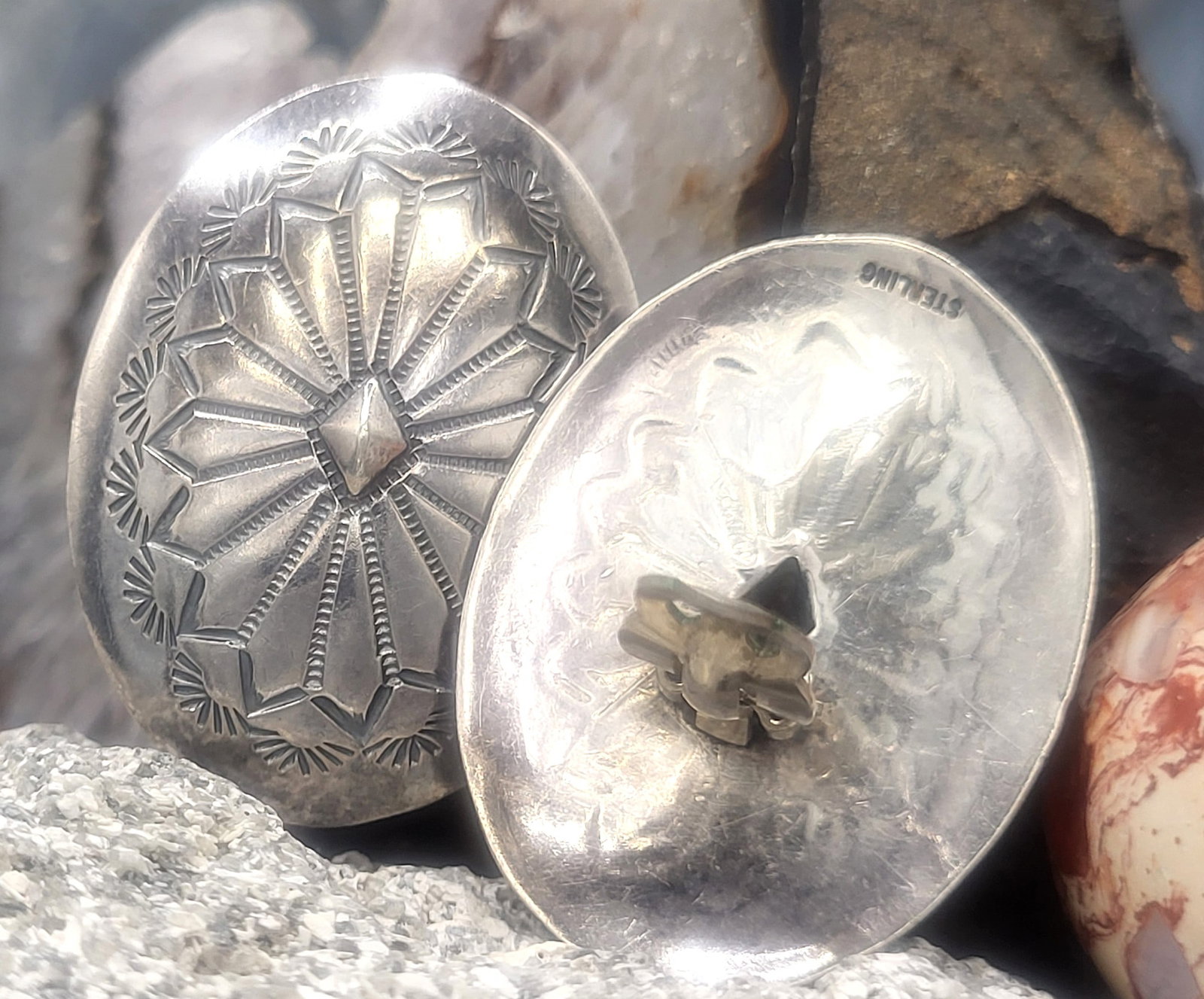 Southwestern Concha Clip-On Earrings .925: 700164 Setting: Sterling Silver Navajo Jewelry Design Style: Clip-On Non-Pierced Weight: 14.22g These sterling silver earrings are die-struck "links" resembling those of the iconic Western wear "conch