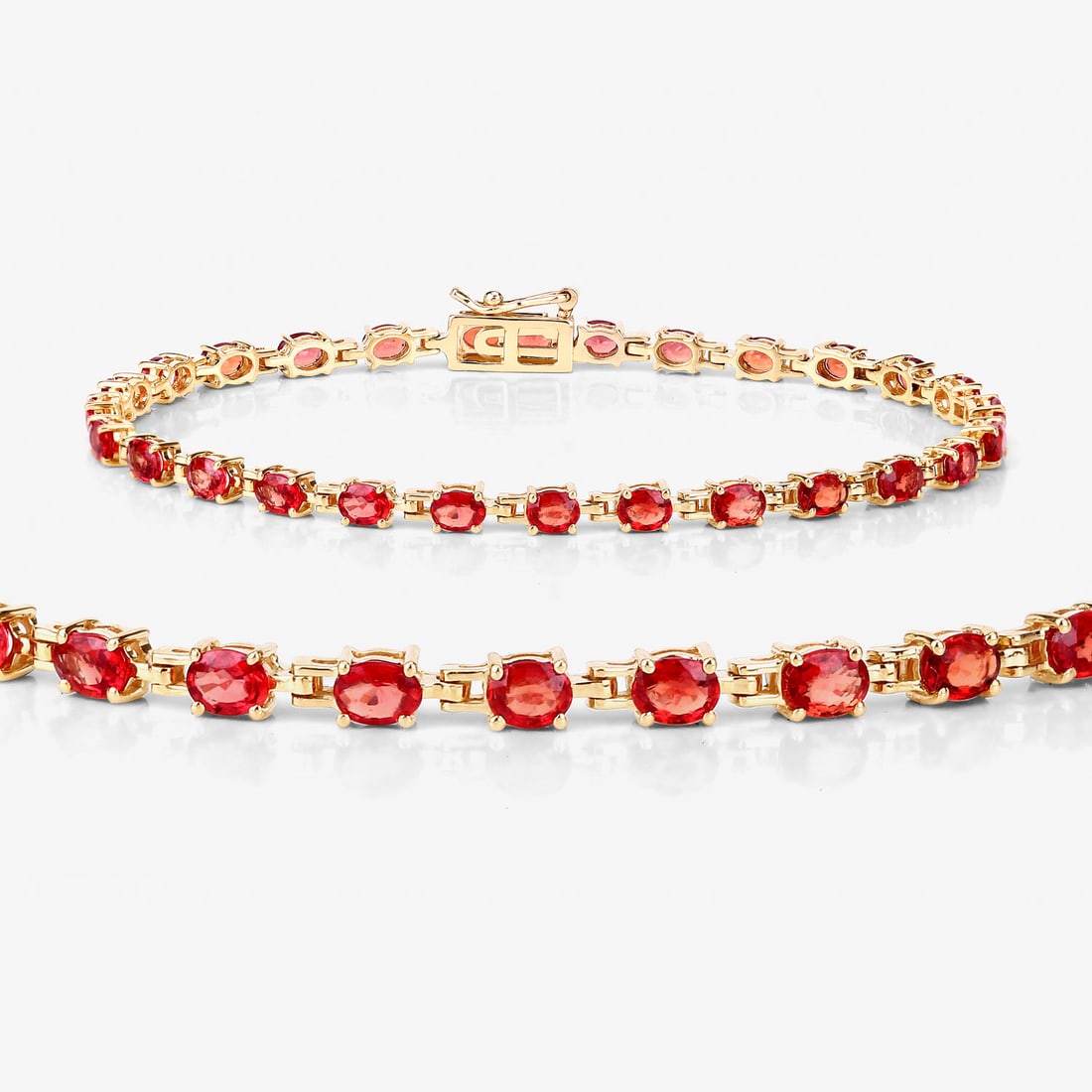 Exotic Orange Sapphire Eternity Bracelet: Setting: 14K Yellow Gold Main Gemstone: Genuine Orange Sapphire Length: 7" Closure: Hidden Box Clasp with Safety Clip Weight: 7.53g This amazing 14 karat yellow gold bracelet features 7.00 carats of i