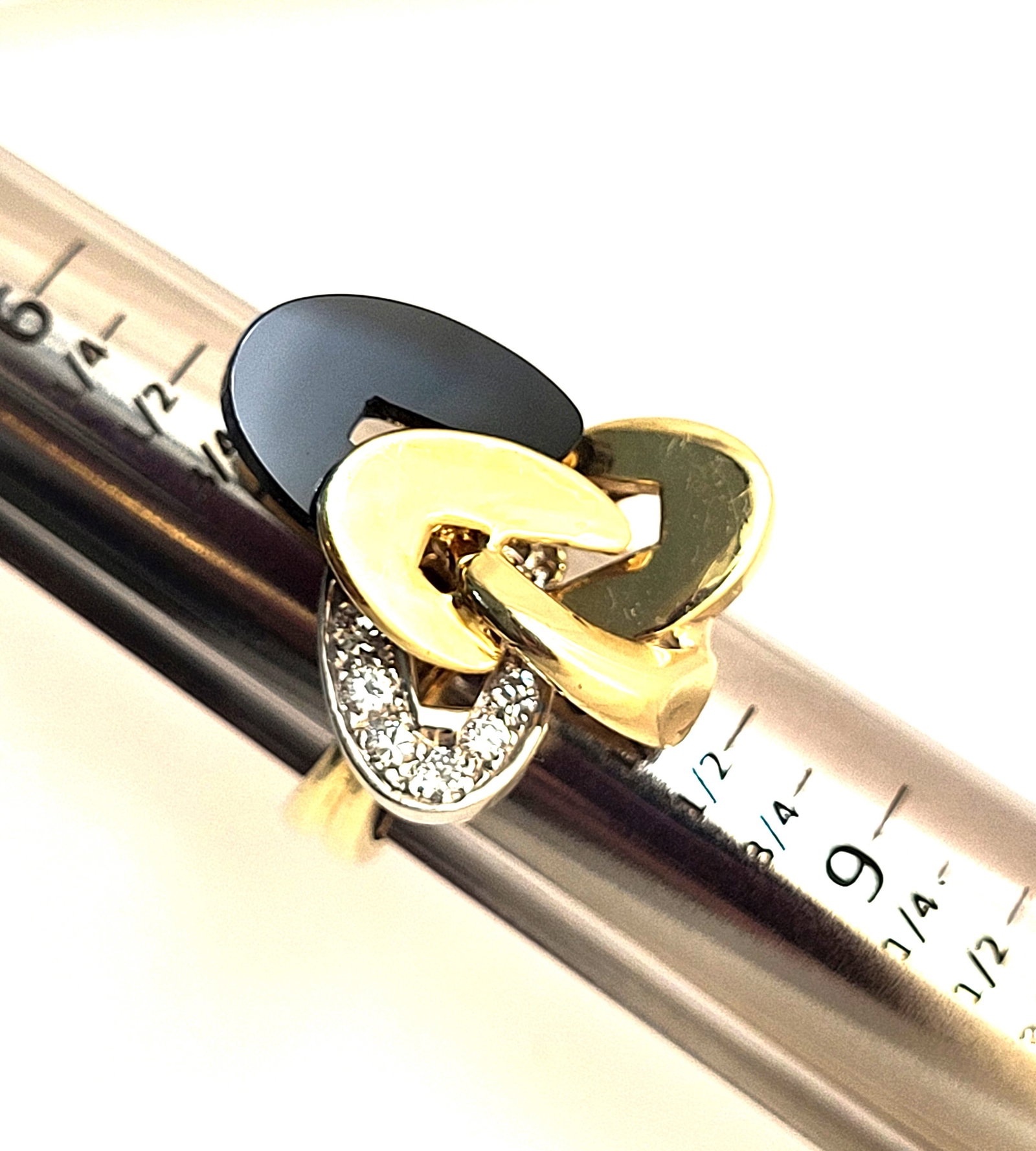 "Onyx in Orbit" -18K Onyx and Diamond Ring -Unique: Setting: 18K Yellow Gold Main Gemstone: Fancy Carved Black Onyx Adjacent Gemstone: Genuine, Natural Diamond Size: US 9 Weight: 14.8g Comparative Retail Price: $3495-$6249 "Onyx In Orbit" is this ring'