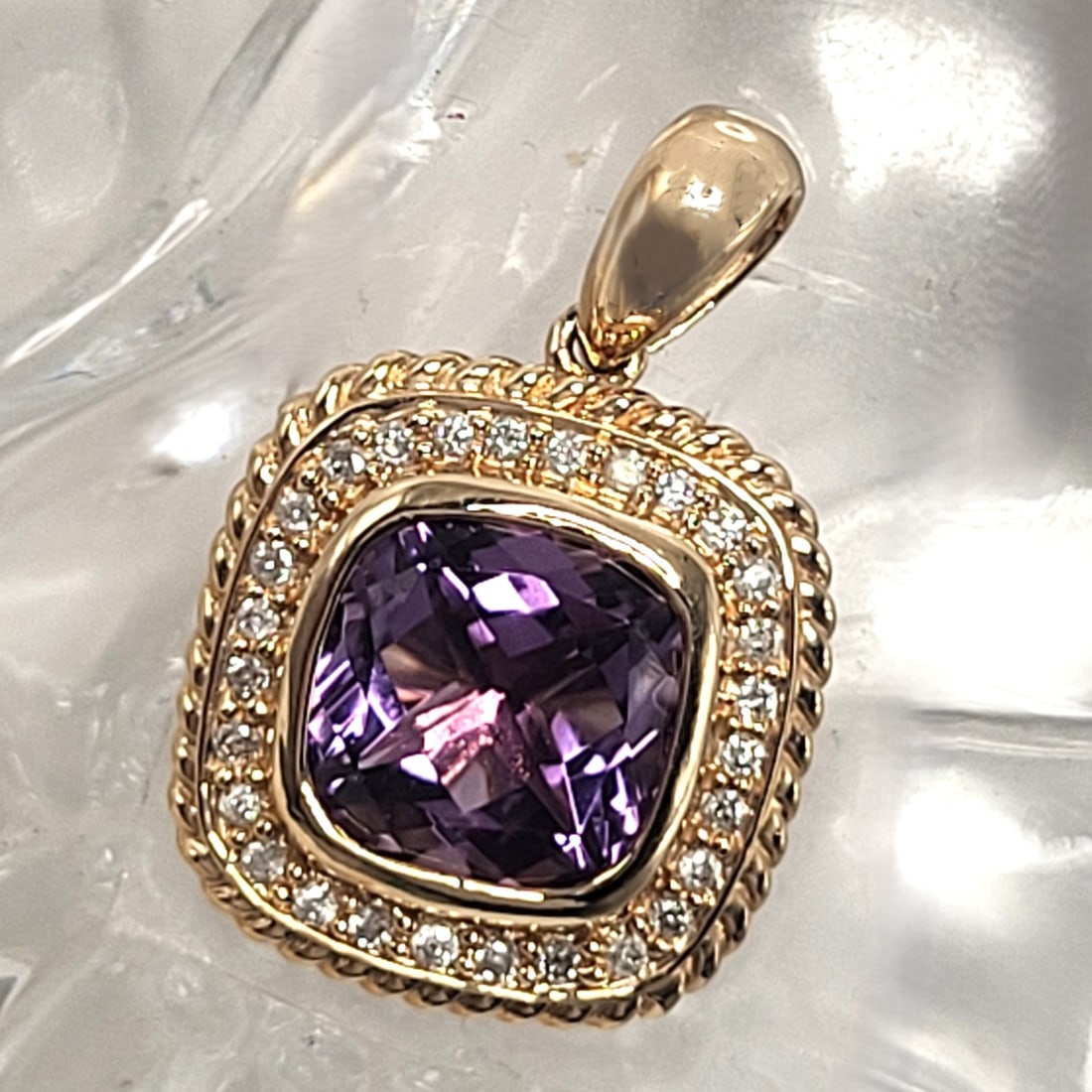 Brazilian Amethyst and Diamond Halo Pendant: 100030 Setting: 14K Yellow Gold Main Gemstone: Genuine Amethyst Geographic Origin: Brazil Adjacent Gemstone: Genuine, Natural Diamond Weight: 3.9g Birthstone for: FEBRUARY This is
