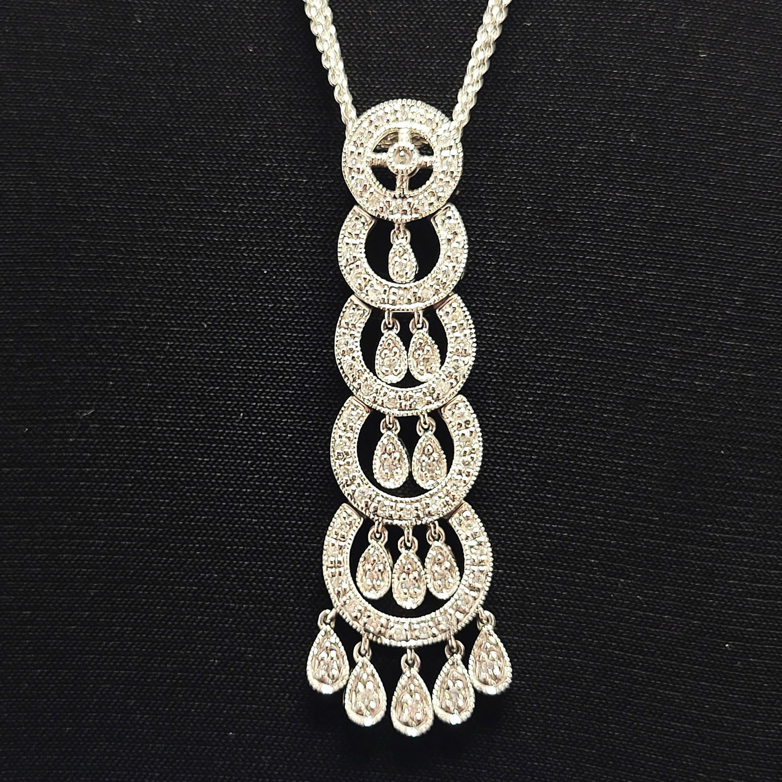14K Diamond Chandelier & Festoon Celebration of Love Necklace: Setting: 14K White Gold Main Gemstone: Genuine, Natural Diamond Length: 16" plus 2" pendant Weight: 8.37g Comparable Price: 2149.00 Birthstone for: APRIL This is a 14 karat white gold necklace that fe