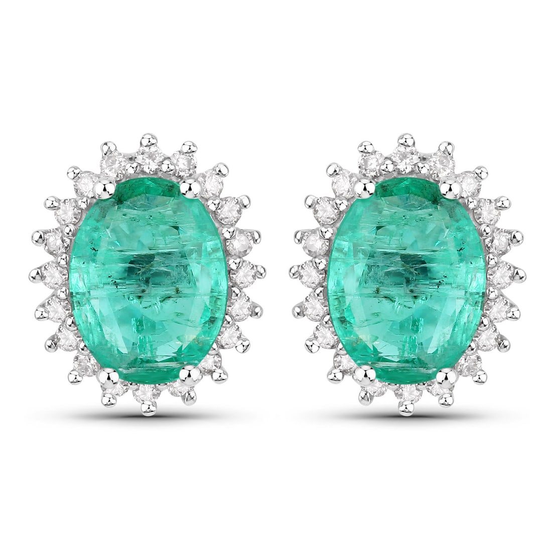 Genuine Zambian Emerald and Diamond Halo Earrings: 27100124 Setting: 14K White Gold Primary Gemstone: Genuine Emerald Geographic Origin: Zambia Secondary Gemstone: Genuine, Natural Diamond Closure: Posts and Friction Backs Weight: 2.63g These 14 karat