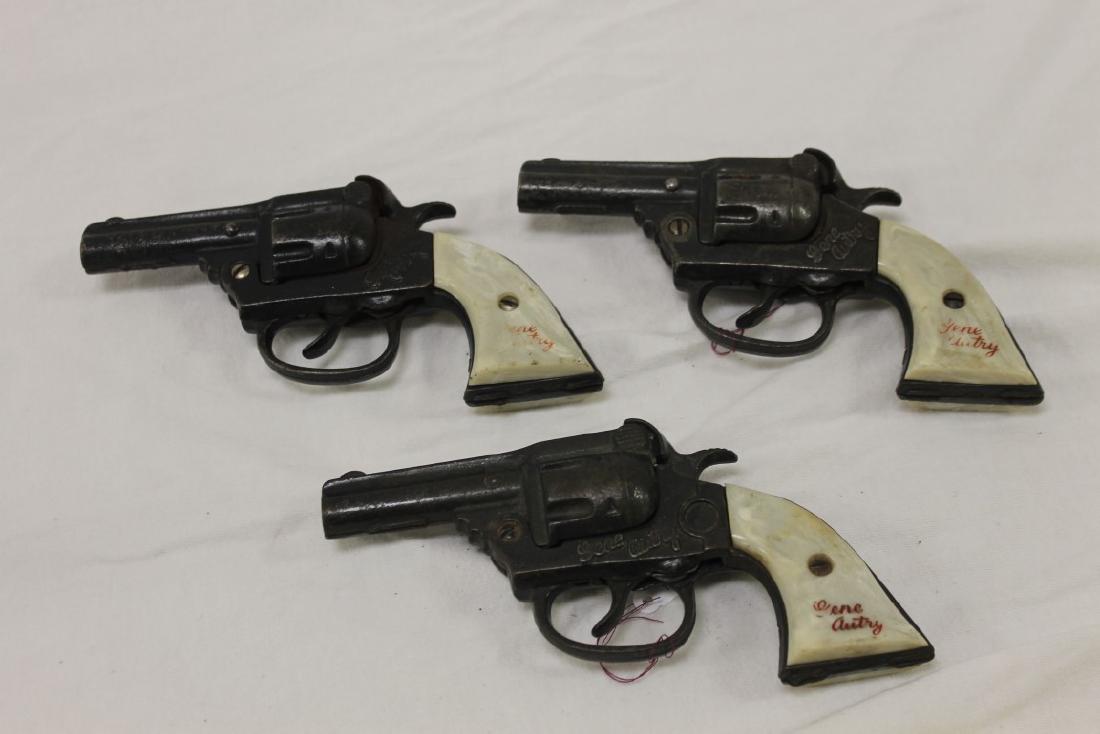 Kenton "Gene Autry" cast iron cap guns, (2) c. 1939 and: Kenton "Gene Autry" cast iron cap guns, (2) c. 1939 and marked Made in USA, Pat Apld For; One is c. 1940 and marked Made in USA. Name wear on grips.