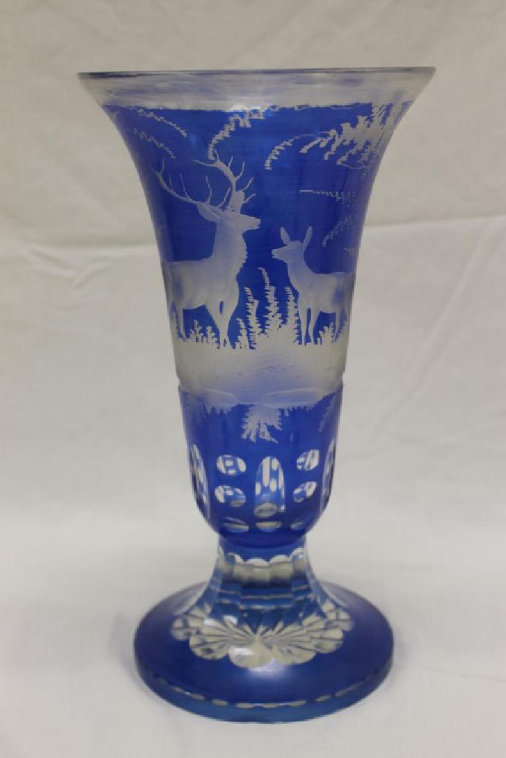 Fine blue Bohemian cut-to-clear trumpet vase with: Fine blue Bohemian cut-to-clear trumpet vase with etched stag and doe in a landscape. Small underside base chip has been ground, 12 3/4" tall, 6 3/4" wide.