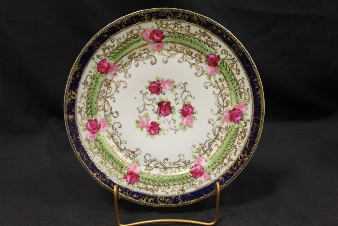 Nippon green M with leaf marked cobalt rim 10" plaque: Nippon green M with leaf marked cobalt rim 10" plaque with roses and gold decoration, some gold wear.