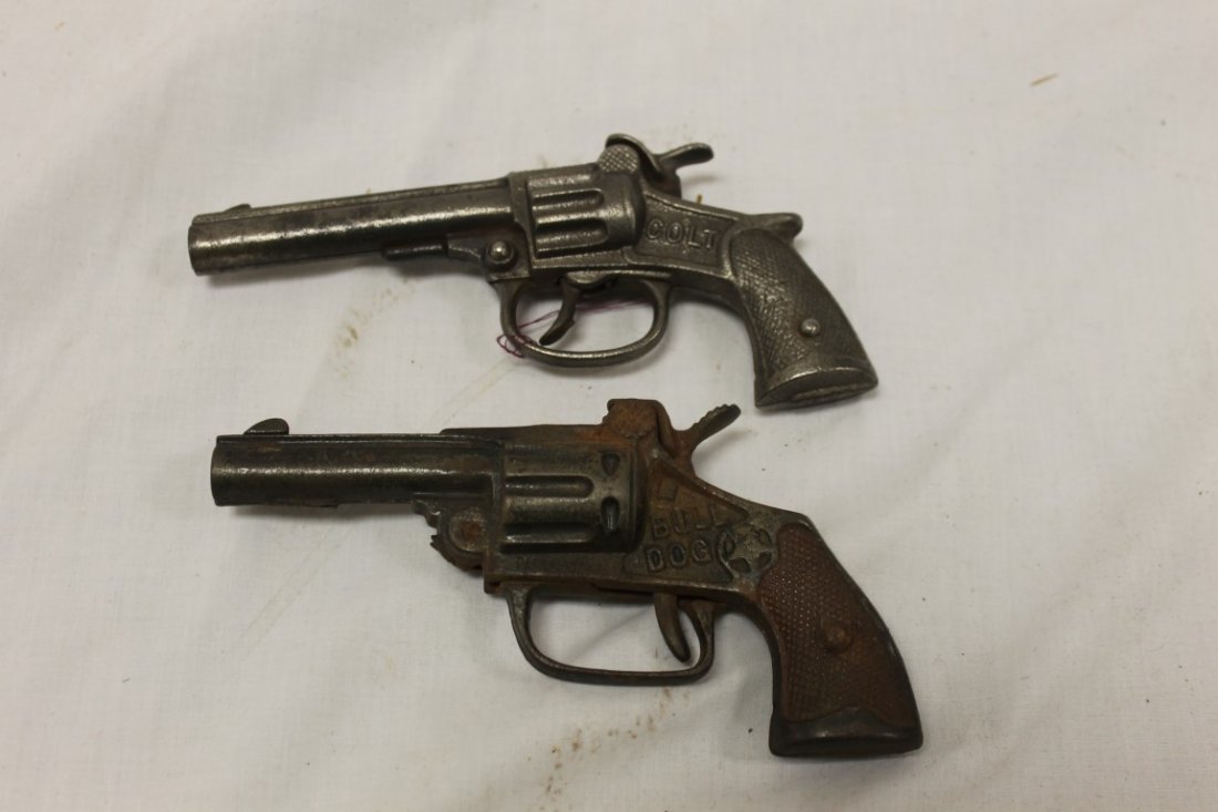 Mammoth Cap Guns: Mammoth Cap Guns: Stevens Colt, 1935, 6 1/2"; Hubley Bull dog, 1935, 6 1/4", with some rusting.