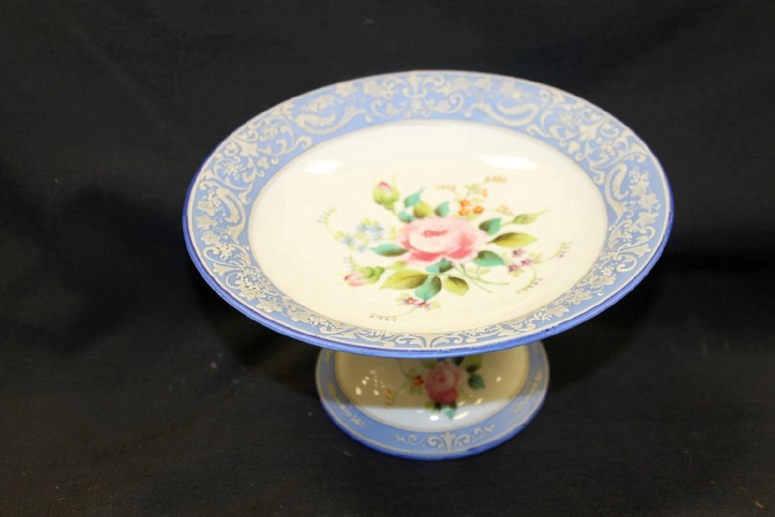 Nippon Green M in wreath 4 3/4" tall compote with blue: Nippon Green M in wreath 4 3/4" tall compote with blue Wedgewood border and rose center, 8 1/2" wide.