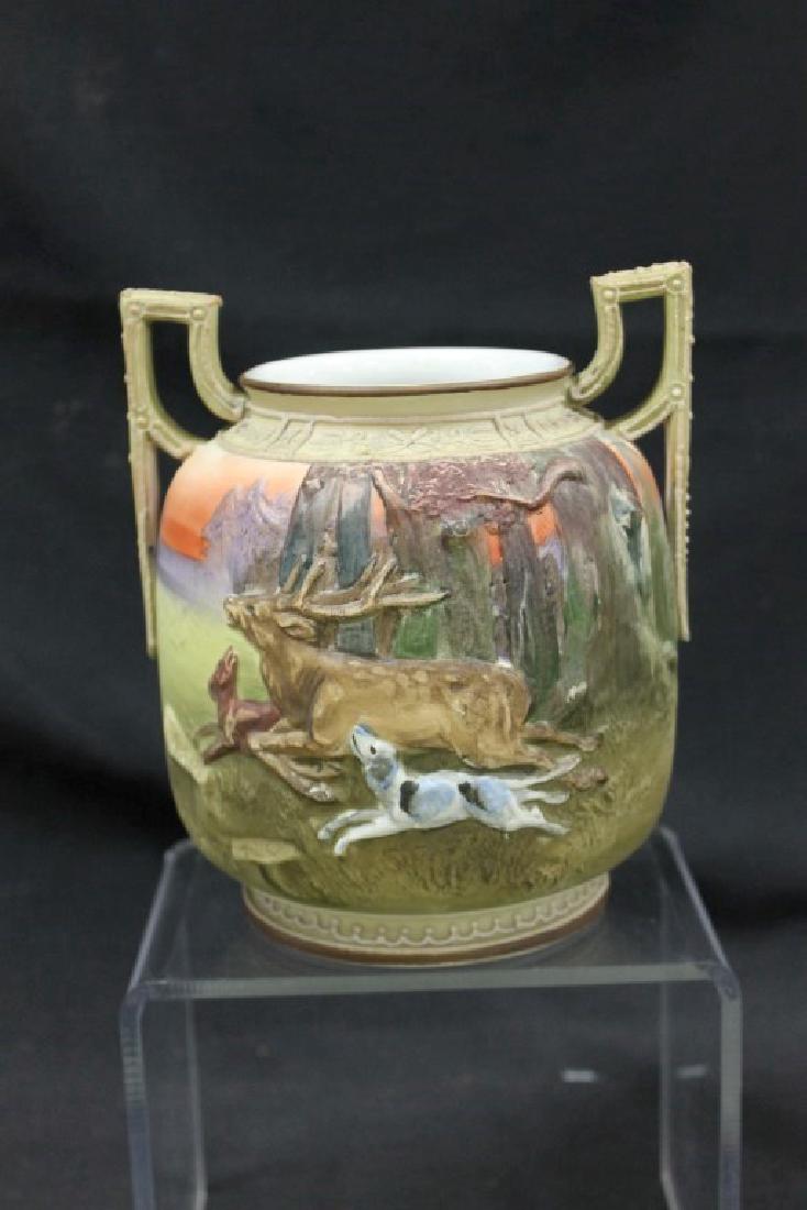 Noritake Made in Japan with Treecrest marked: Noritake Made in Japan with Treecrest marked molded-in-relief 2-handle vase with dogs running a stag. 6 1/2" tall at handles.