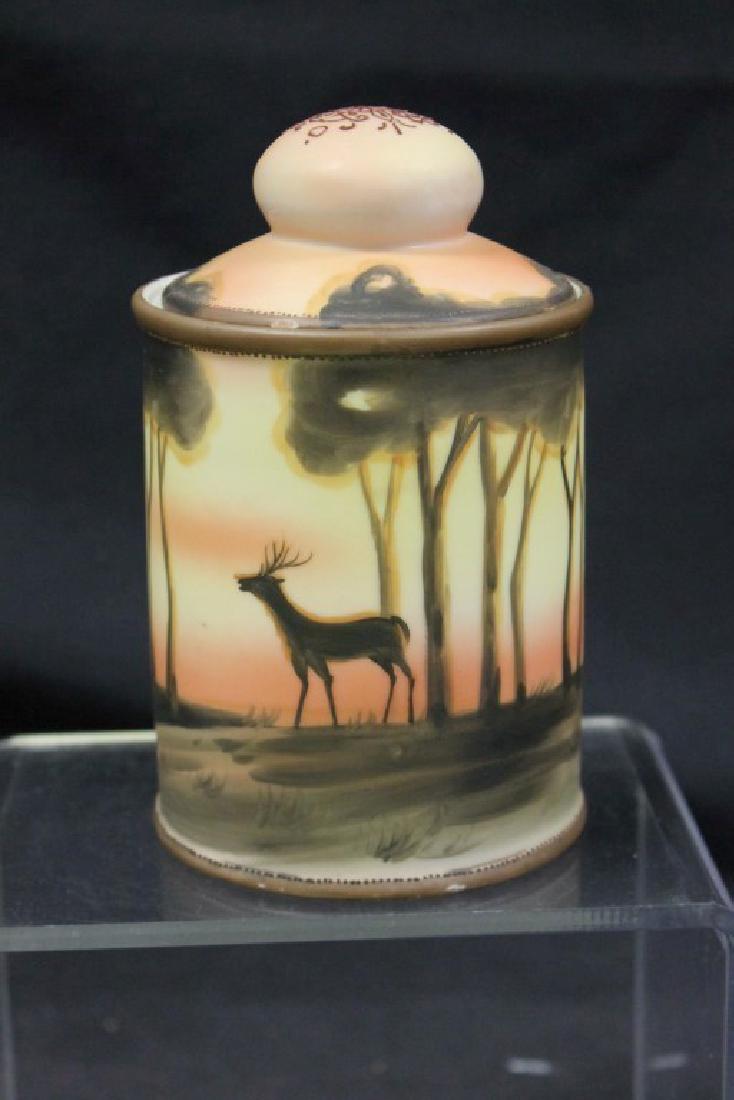 Nippon Green M in wreath 5 3/4" humidor decorated with: Nippon Green M in wreath 5 3/4" humidor decorated with a deer in the forest. Minor rim chip on lid.