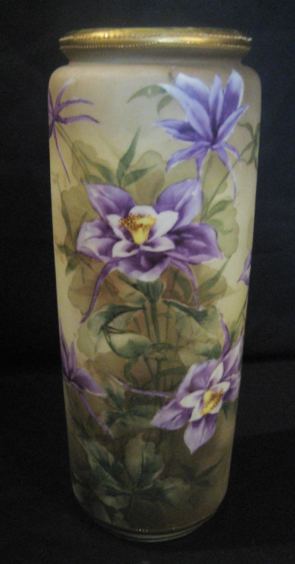 Nippon Blue maple leaf 11 3/4" cylinder vase with: Nippon Blue maple leaf 11 3/4" cylinder vase with purple iris decoration. Minor gold wear on rim.